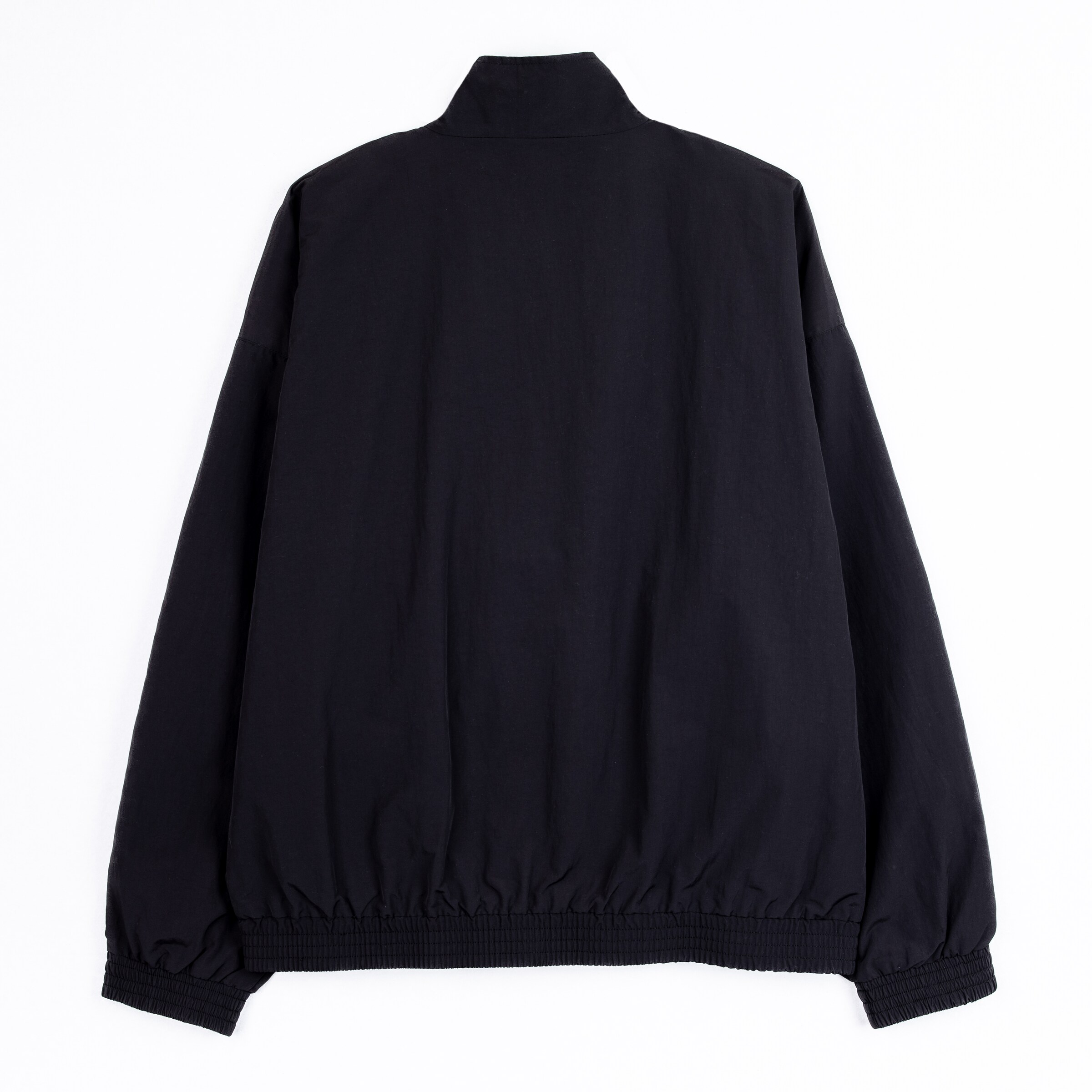 Black loose-fitting jacket with elastic waistband and high collar back view.