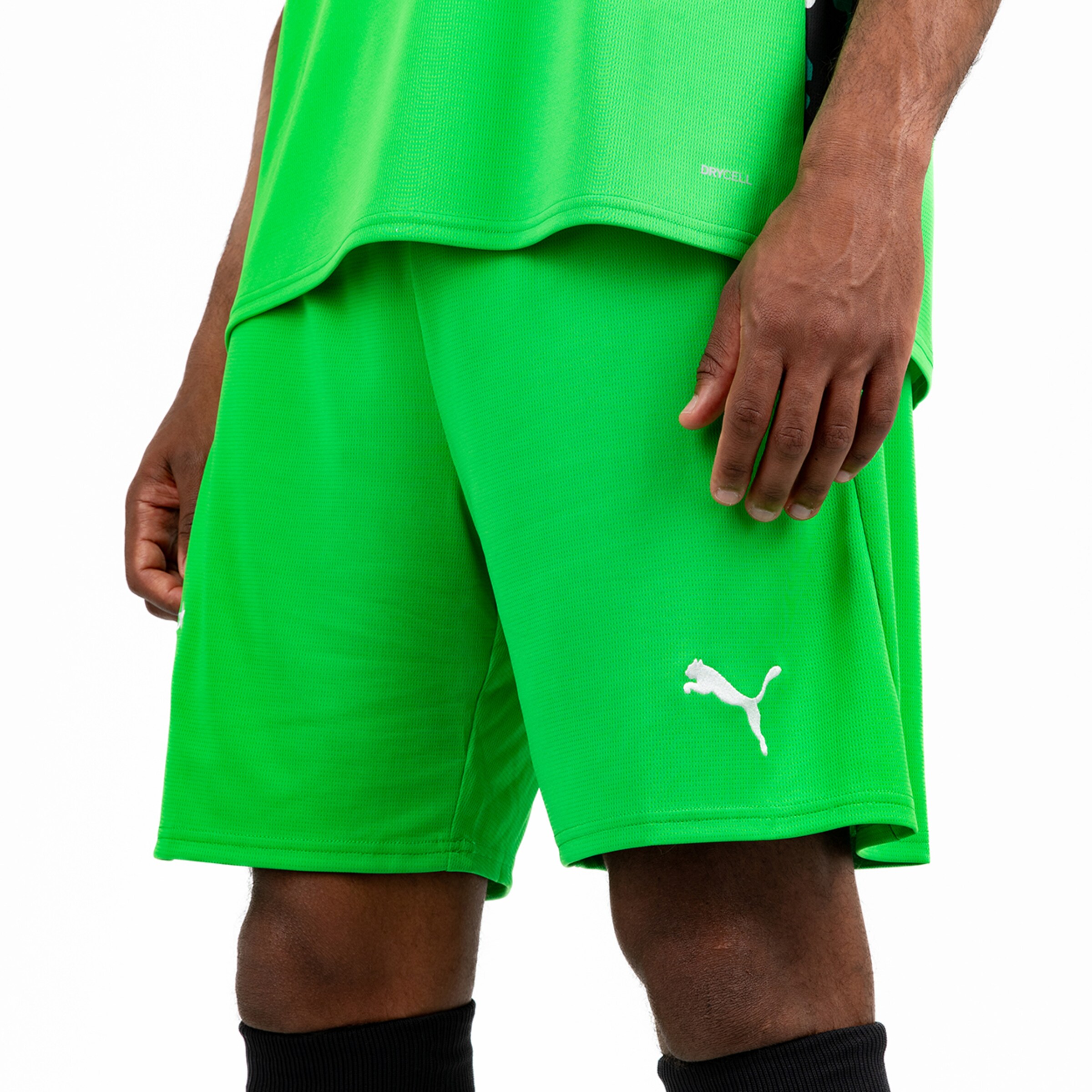 Green sports outfit consisting of a shirt and shorts featuring a Puma logo.