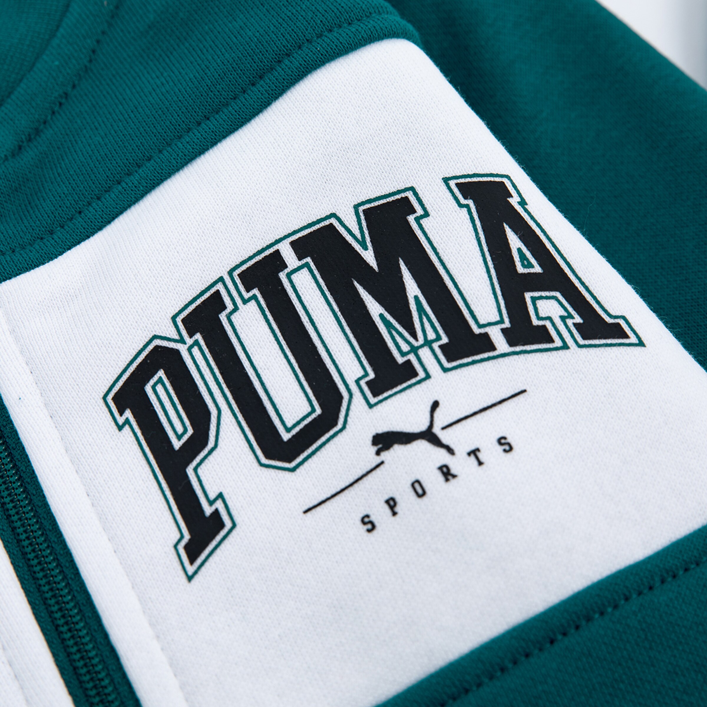 Green jacket with PUMA logo on the chest.