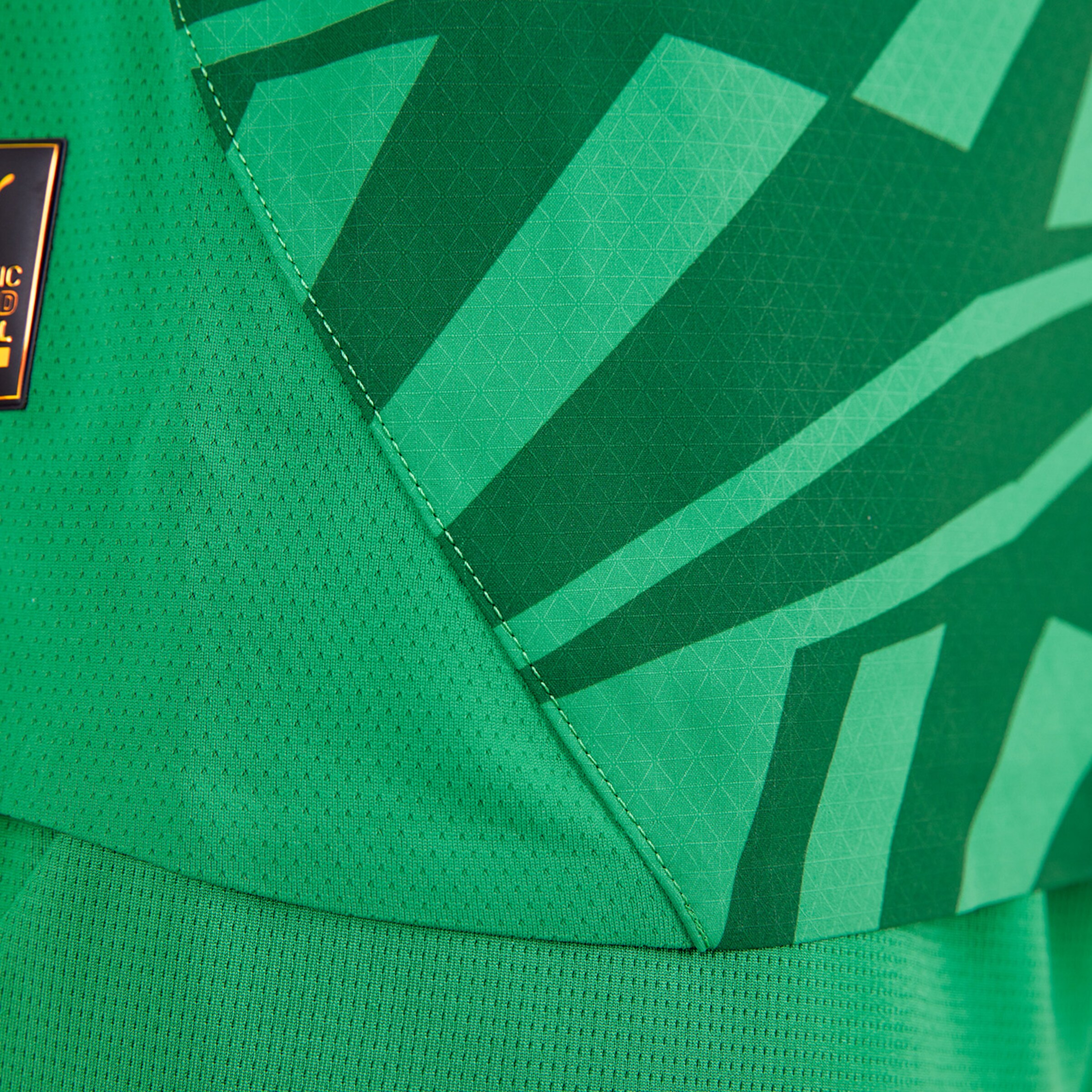 Close-up of a green jersey featuring a geometric pattern.