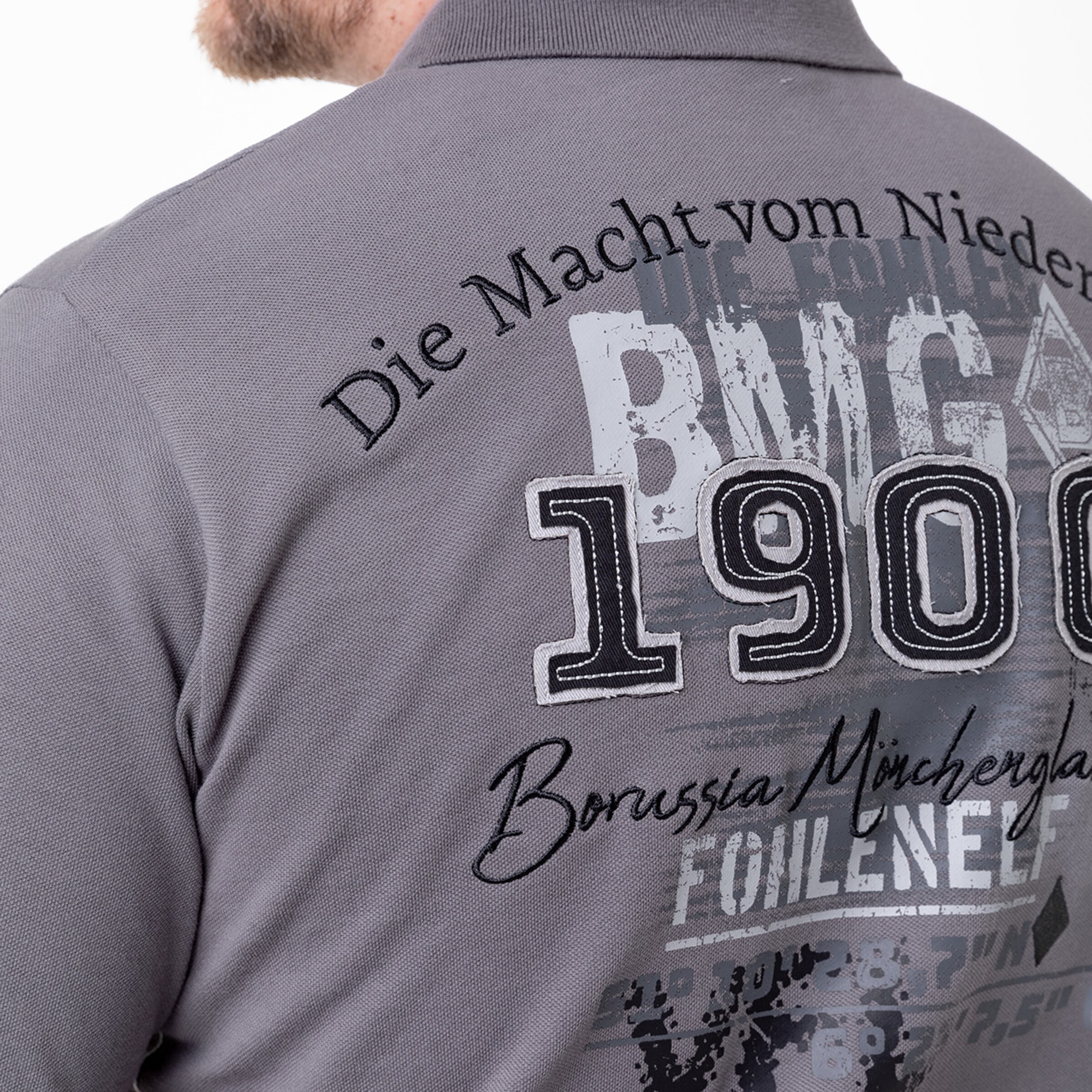 Graues Polo mit BMG 1900 und Die Macht vom Niederrhein auf dem Rücken.