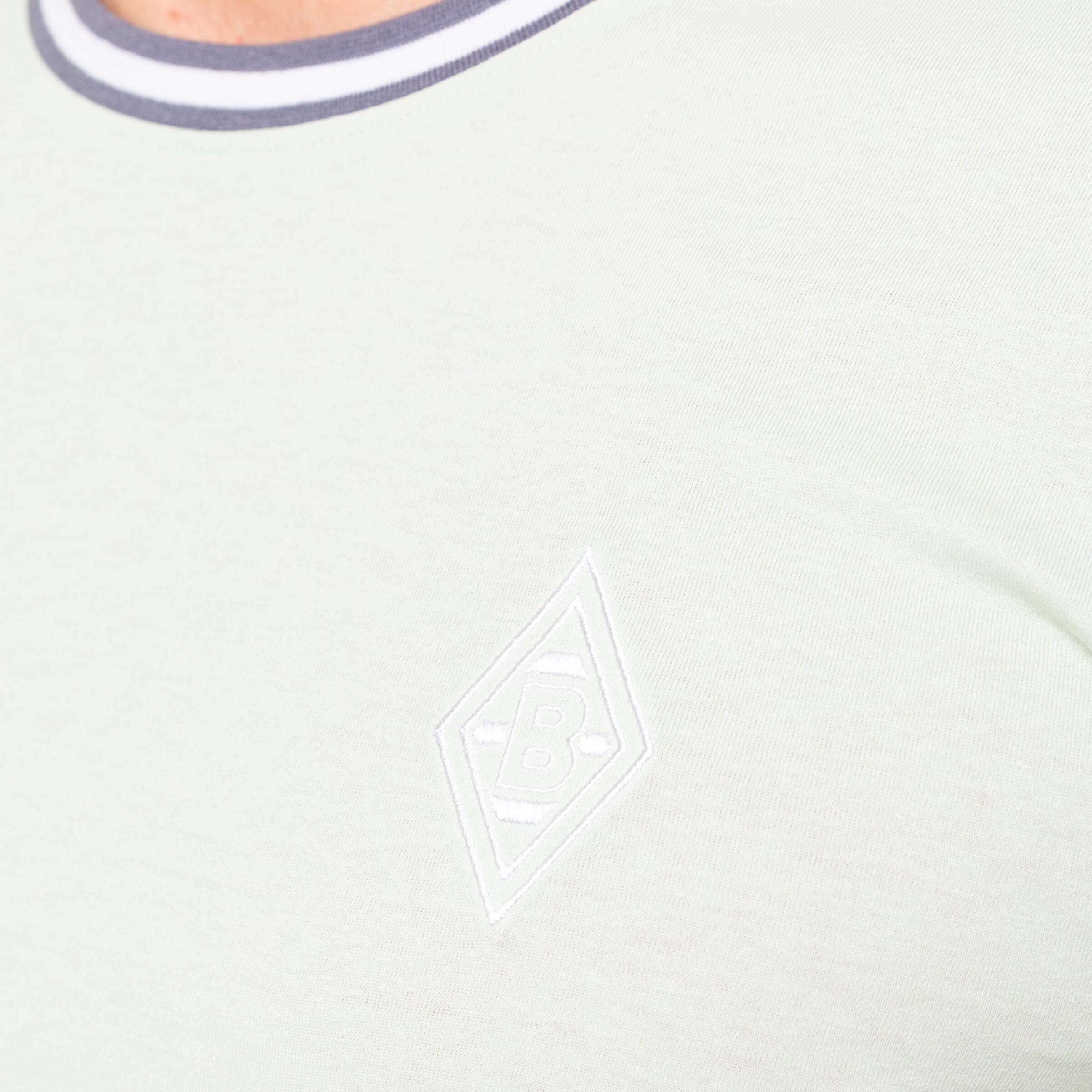 Close-up of a jersey featuring the Borussia Mönchengladbach logo.