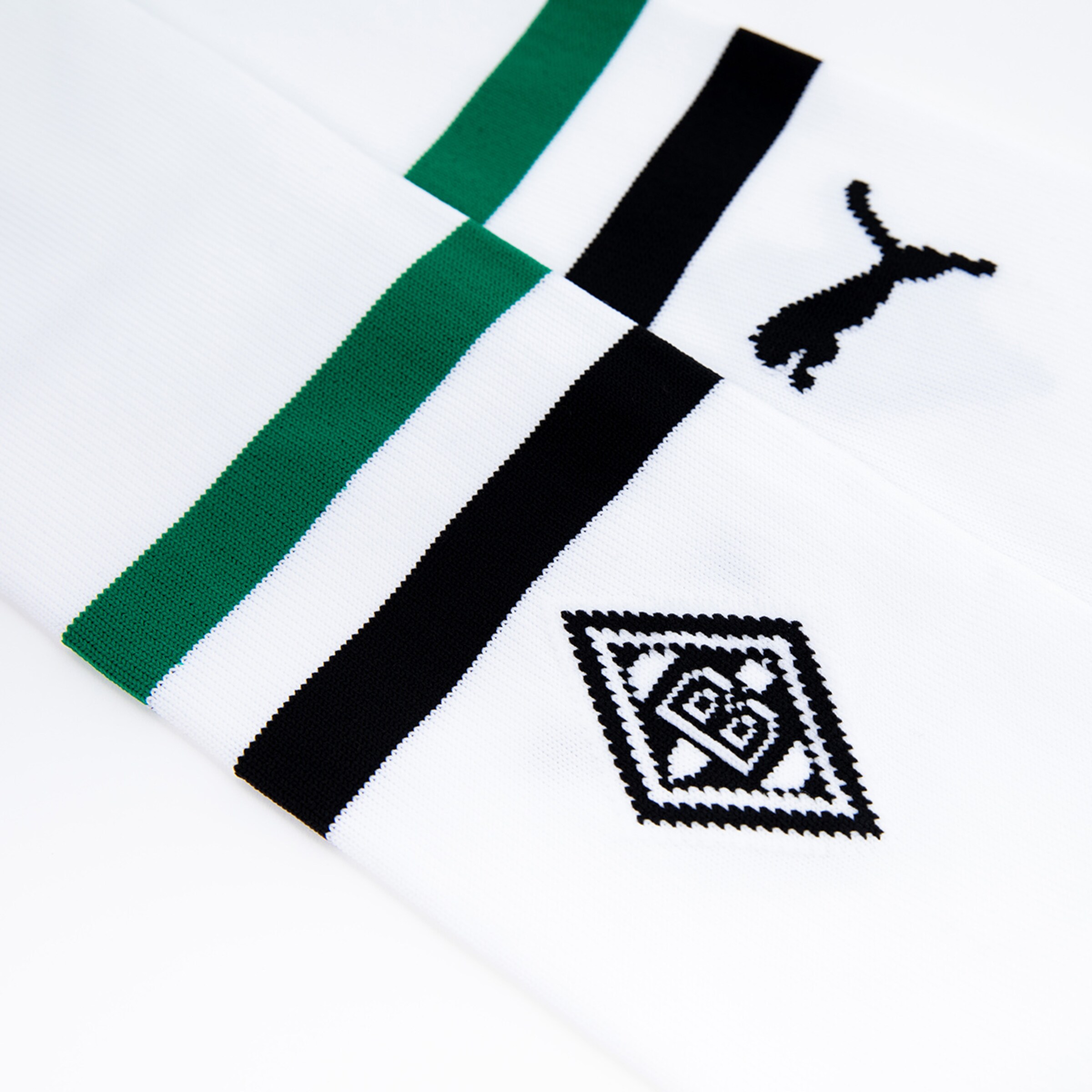 White soccer socks with green and black stripes, featuring the Puma logo and the Borussia Mönchengladbach club crest.
