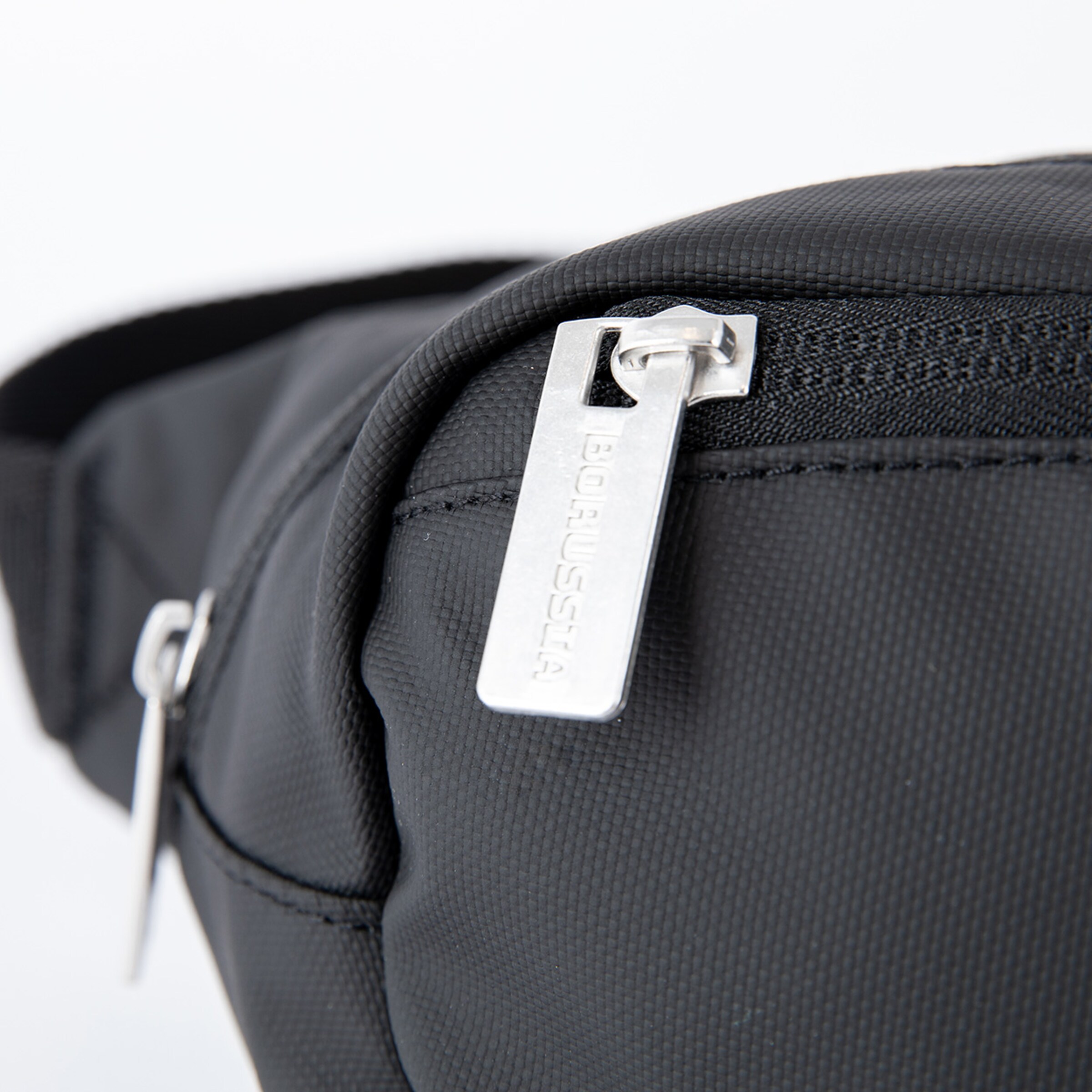 Black sports bag with a silver zipper and the inscription BORUSSIA in metal.