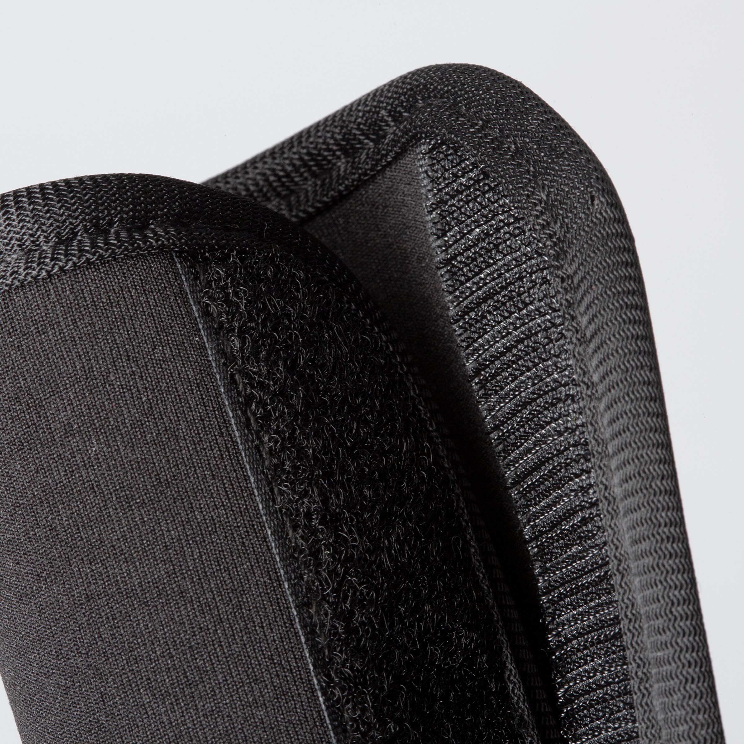 Black soccer shin guard with Velcro detail