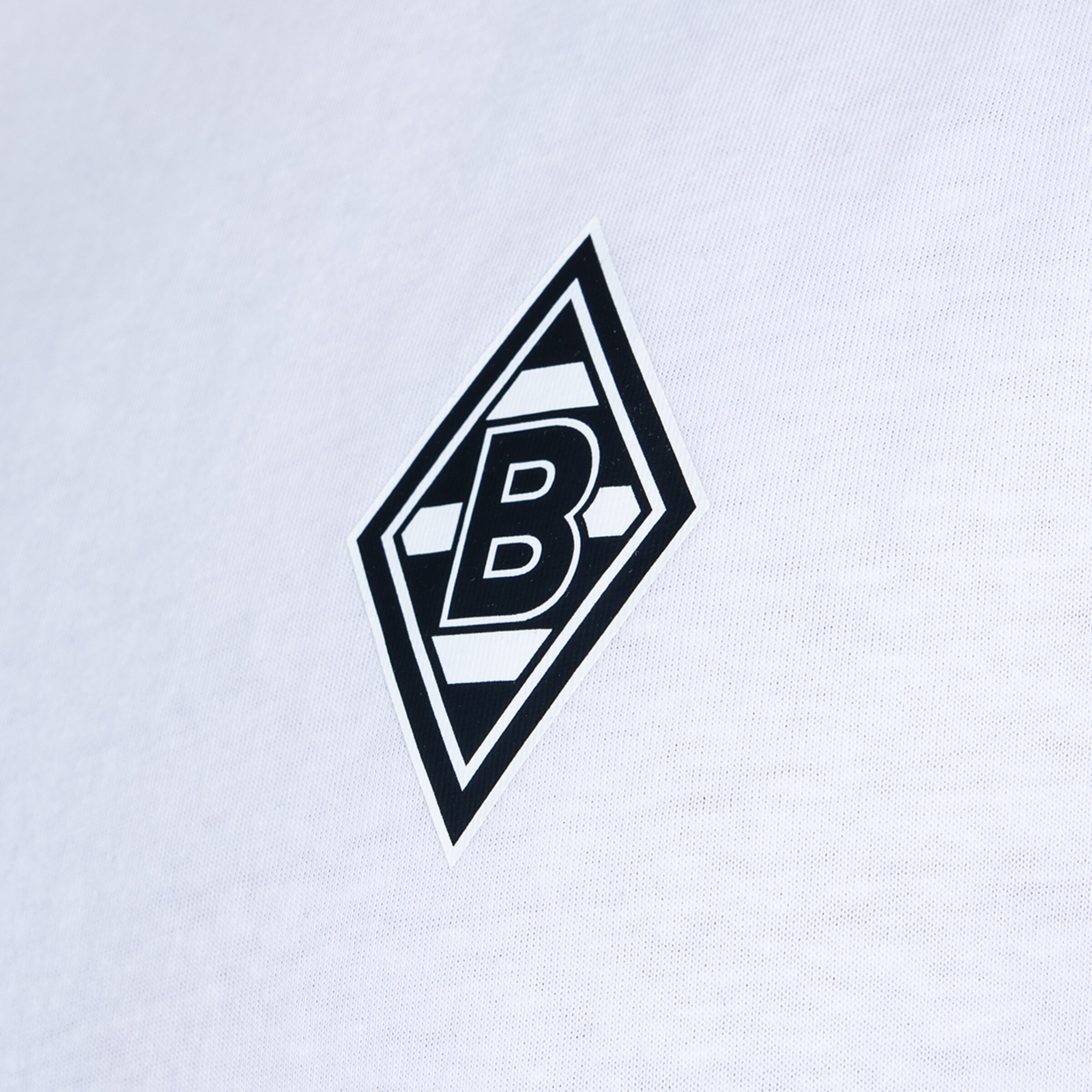 Black and white diamond logo with the letter B, the crest of Borussia Mönchengladbach, on white fabric.