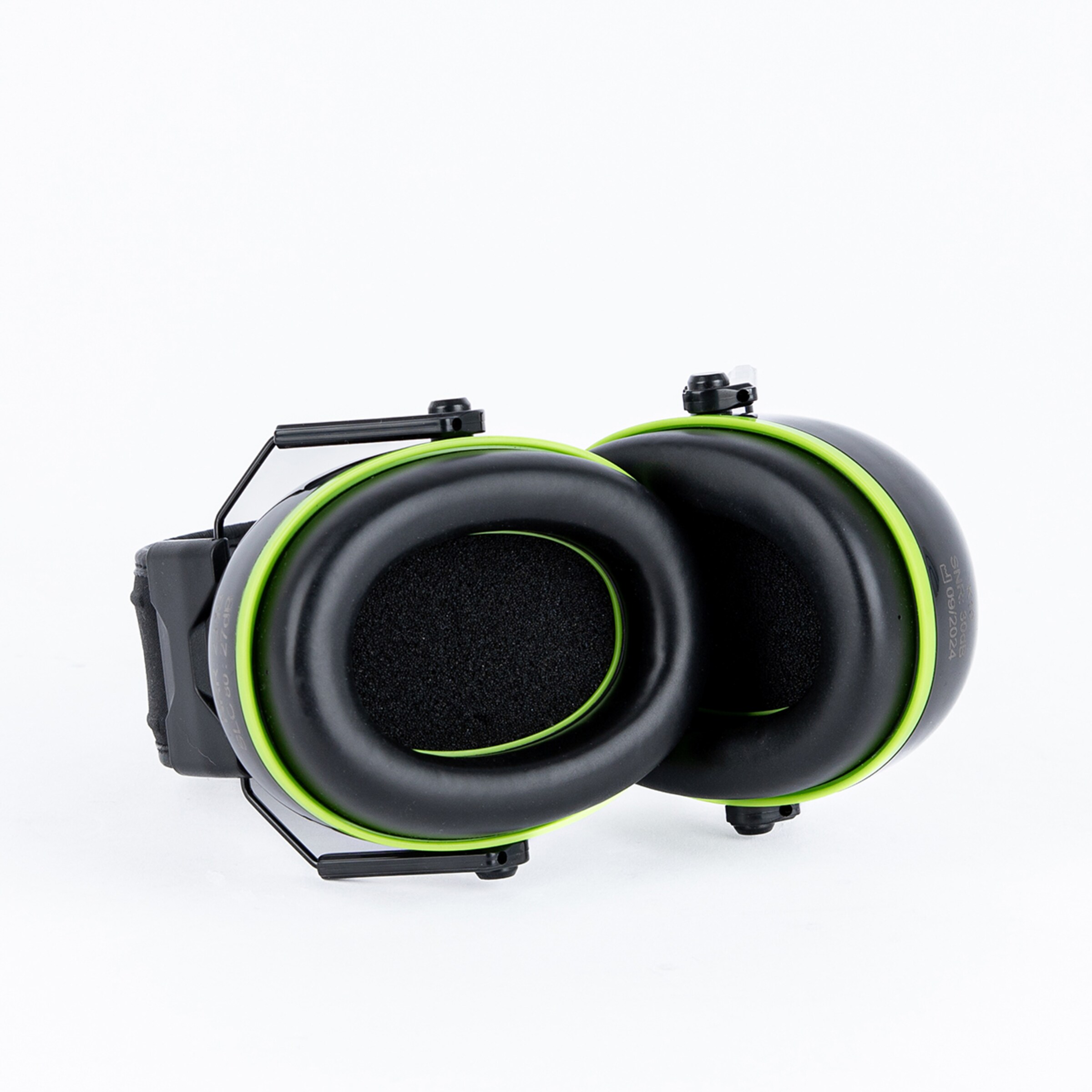 Black and green ear cups with a rigid frame folded together.