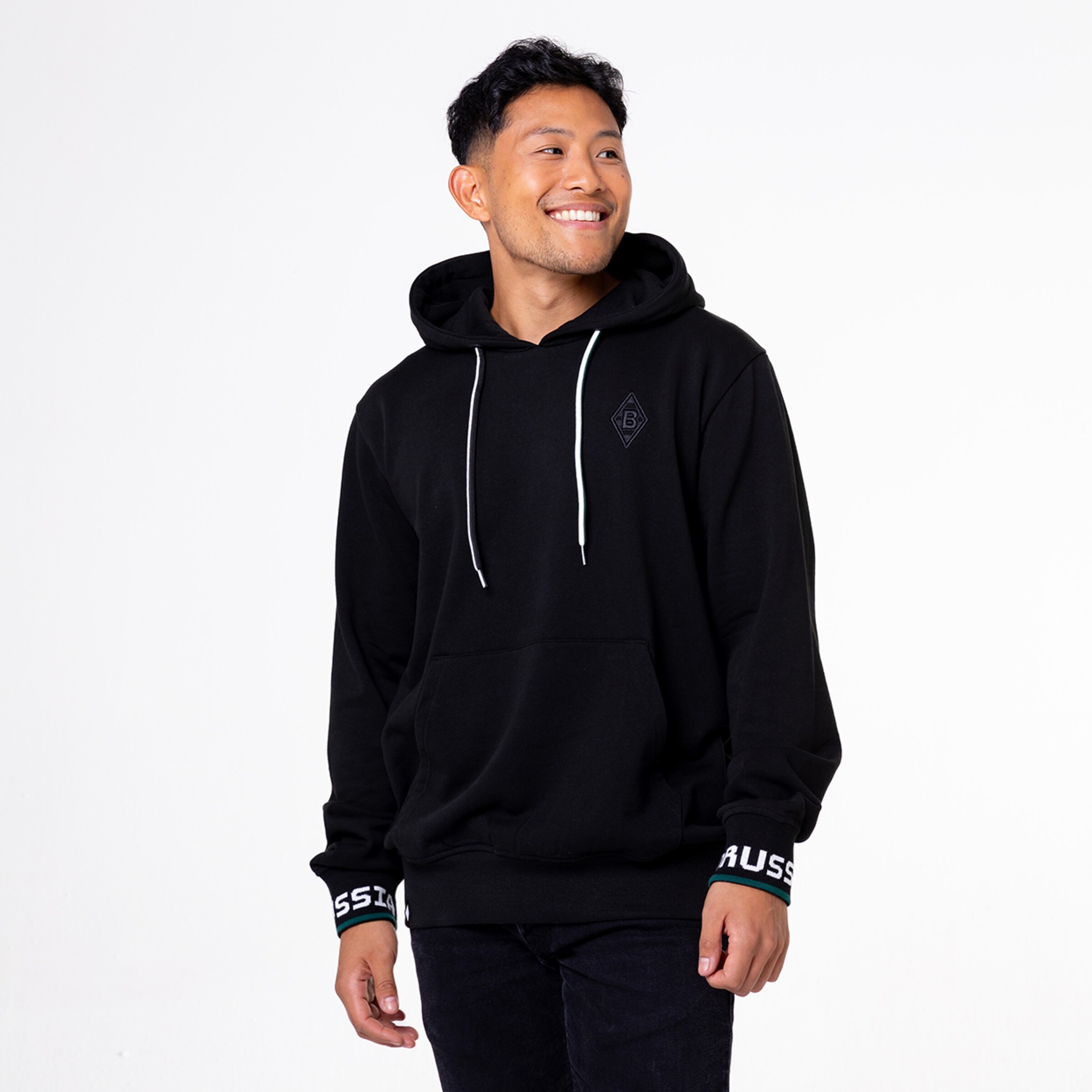 Man wearing a black hoodie with Borussia Mönchengladbach logo and lettering.