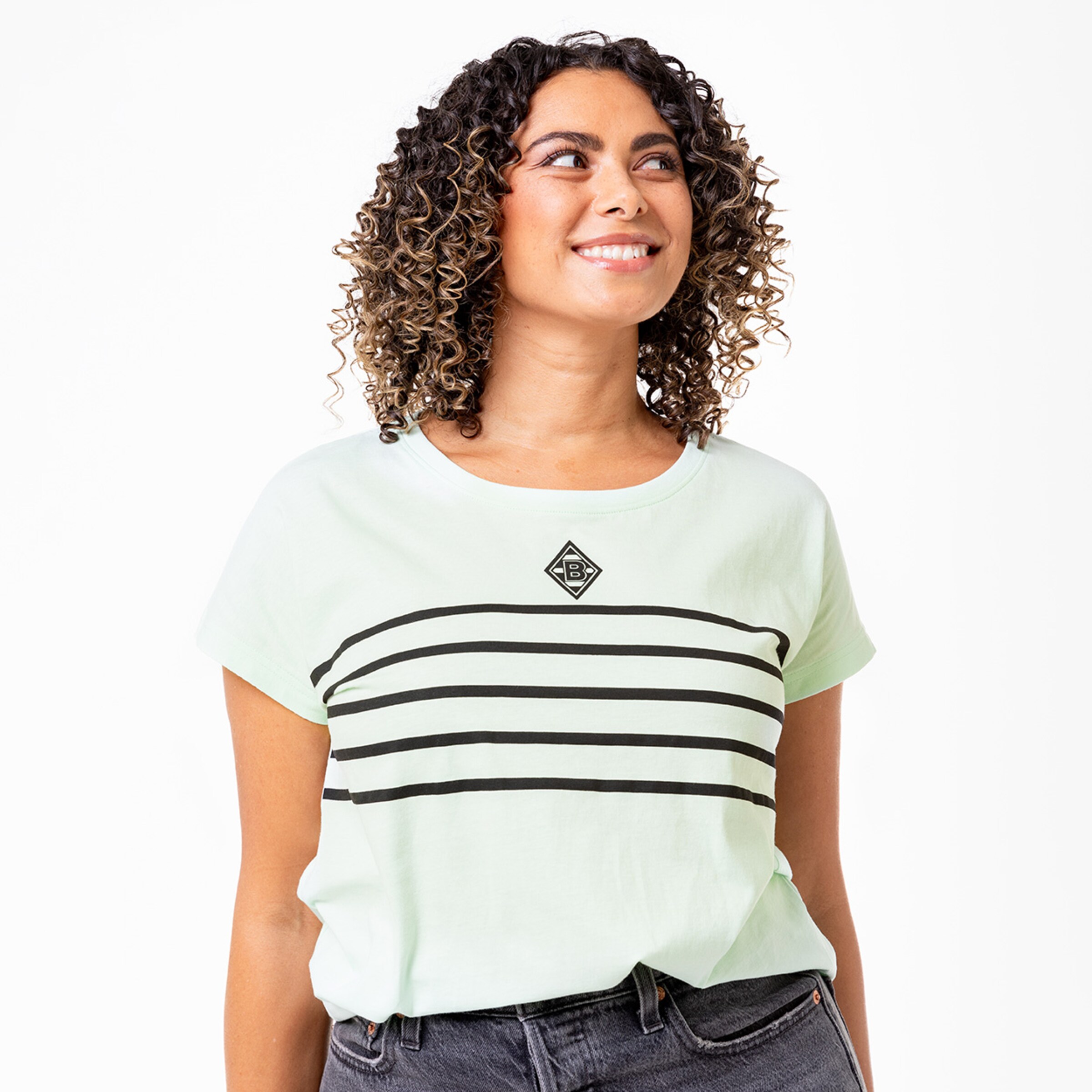 Woman with curly hair wearing a mint green t-shirt featuring black stripes and a Borussia Mönchengladbach logo.