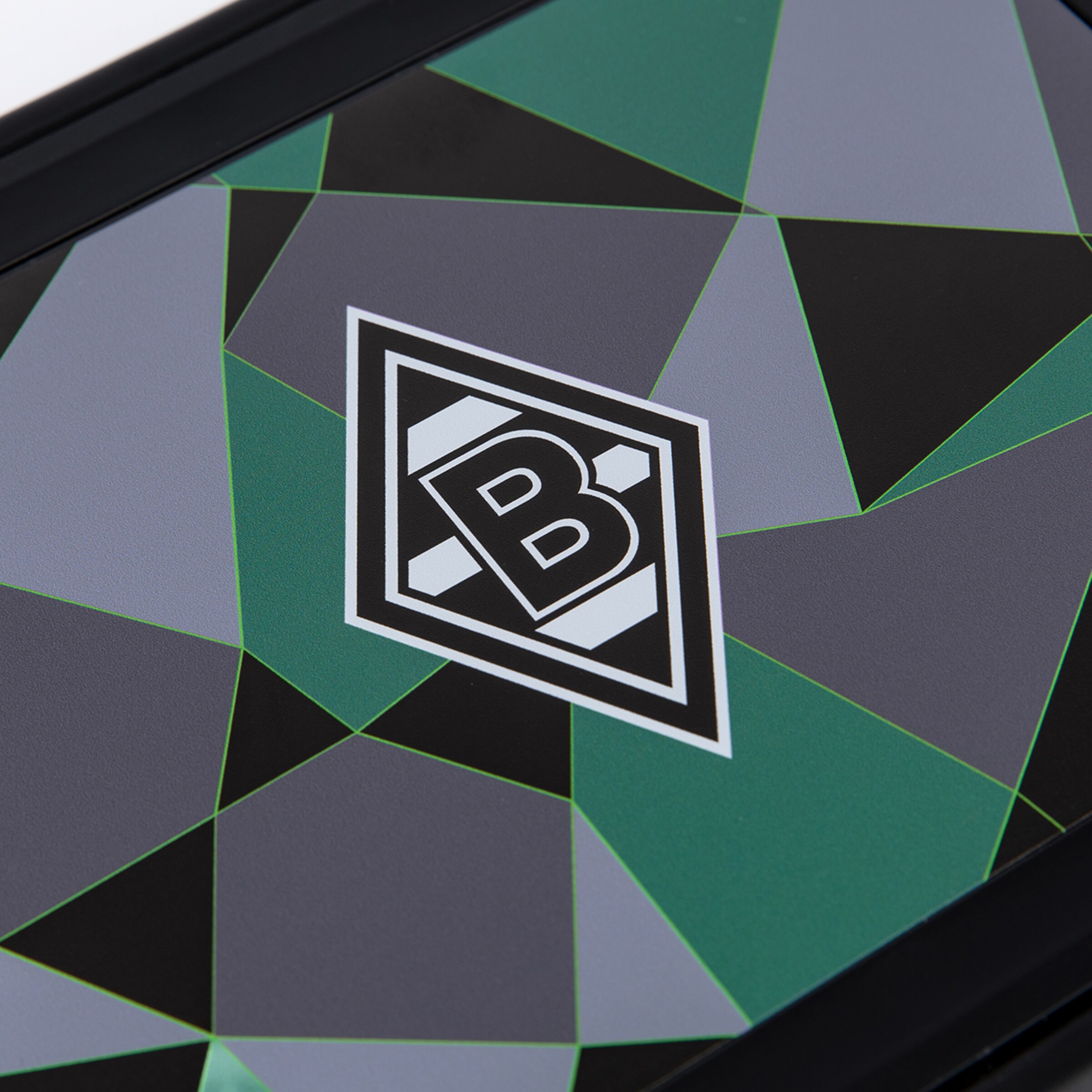 A Borussia Mönchengladbach mousepad featuring the club's logo in white and black, set against a background of polygonal shapes in dark grey, light grey, black, and green, framed by a black border.