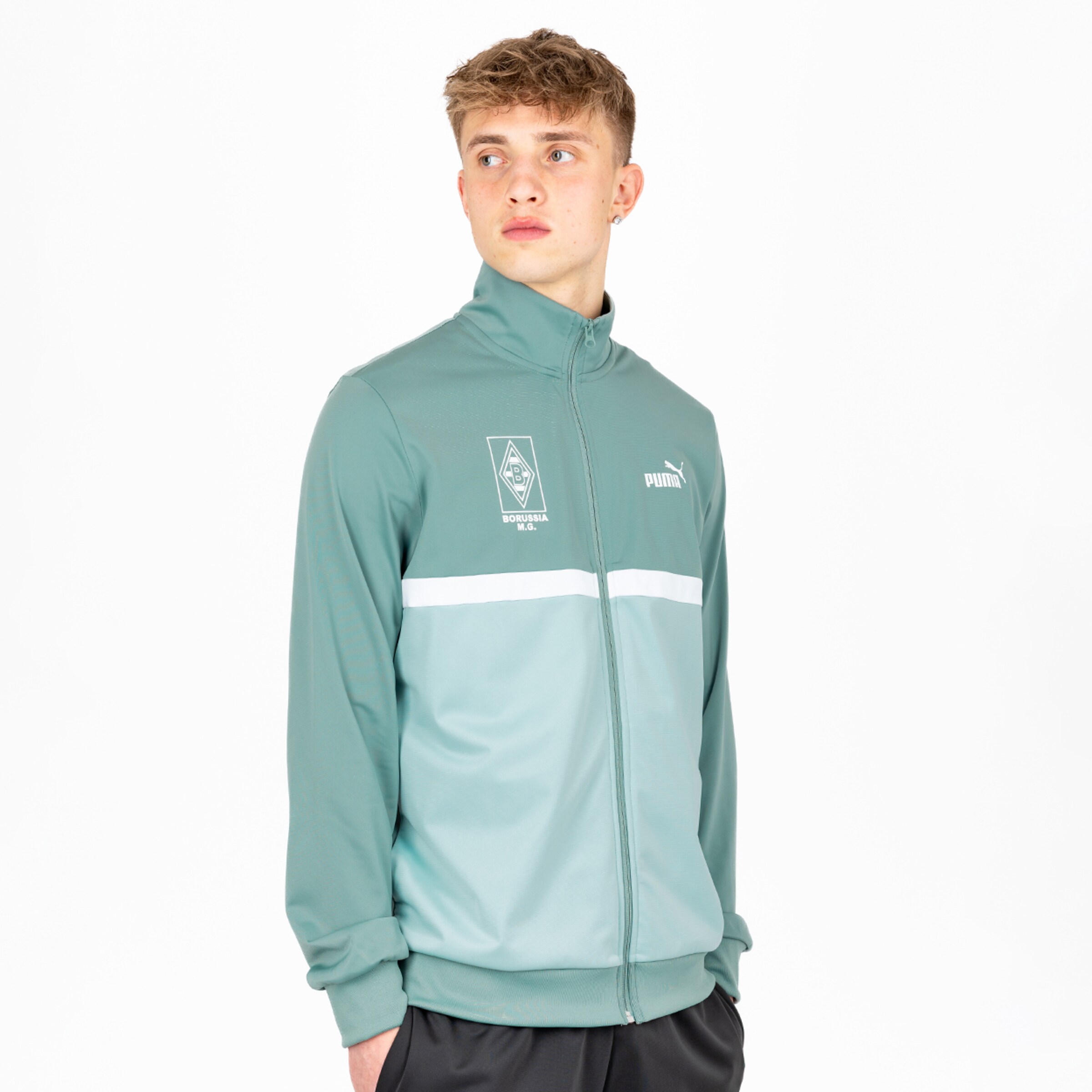 Youth stands in a sports jacket featuring the Puma logo and Borussia Mönchengladbach emblem.