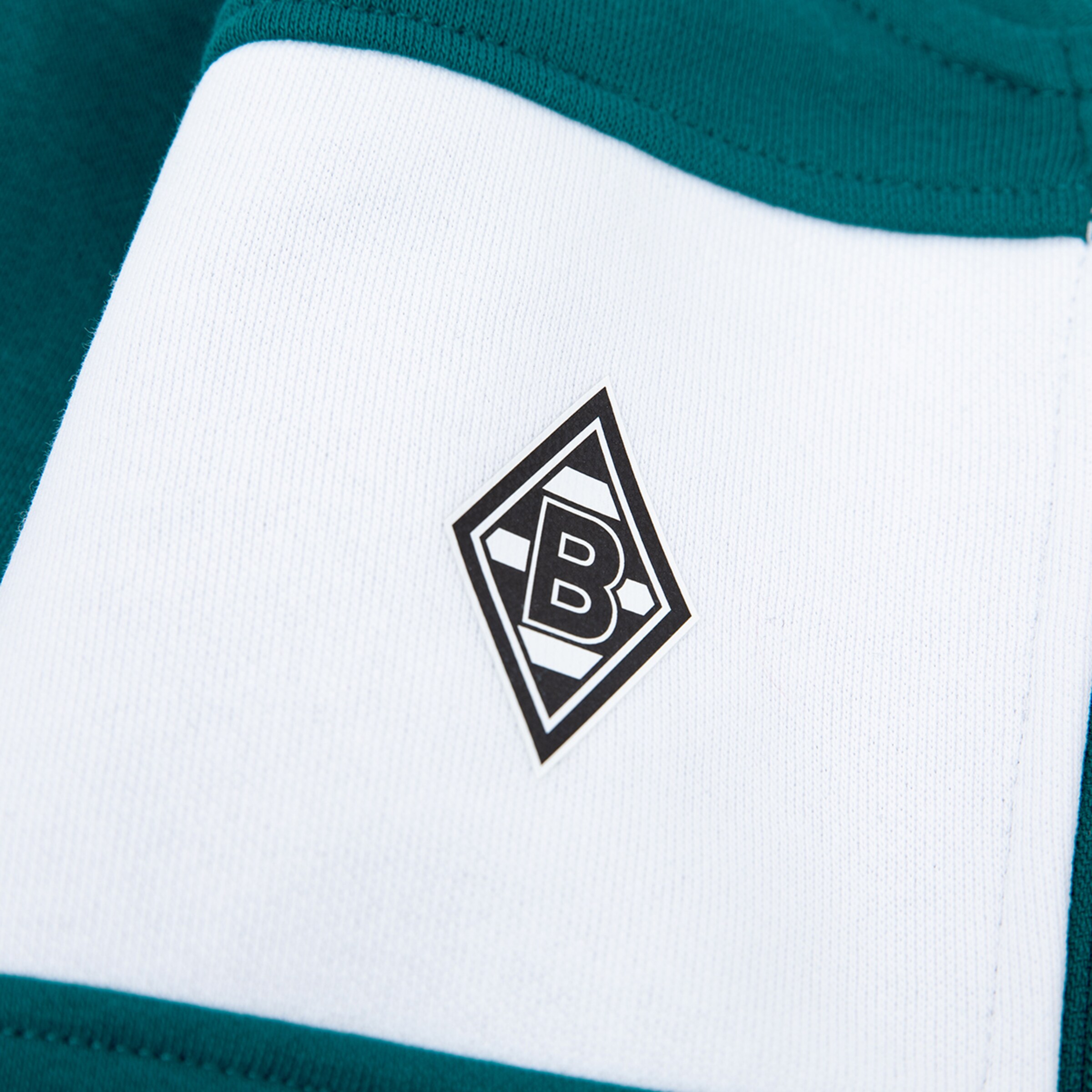 Black and white Borussia Mönchengladbach logo on teal and white sportswear.