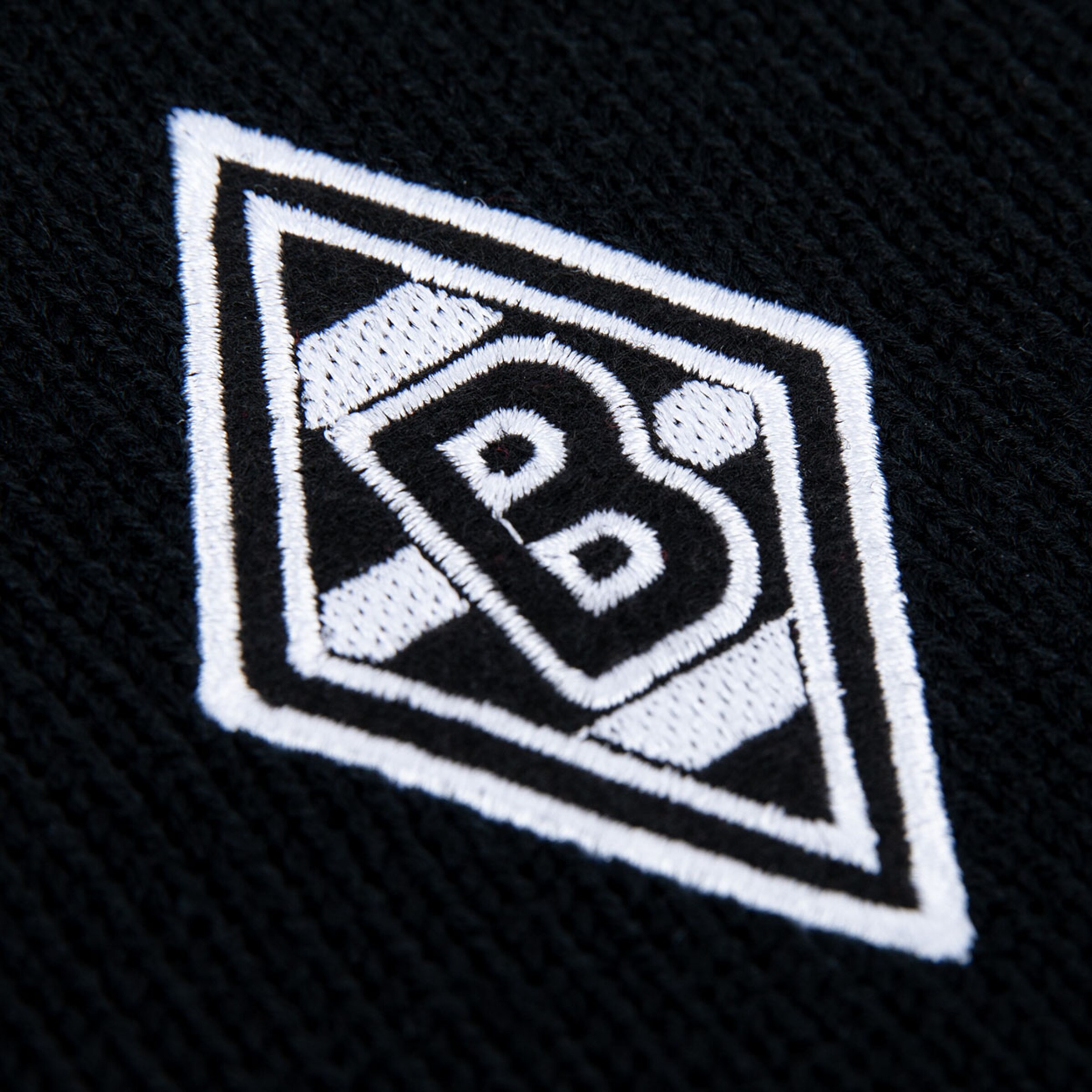 Logo von Borussia Mönchengladbach mit schwarzem Hintergrund und weißem Emblem.