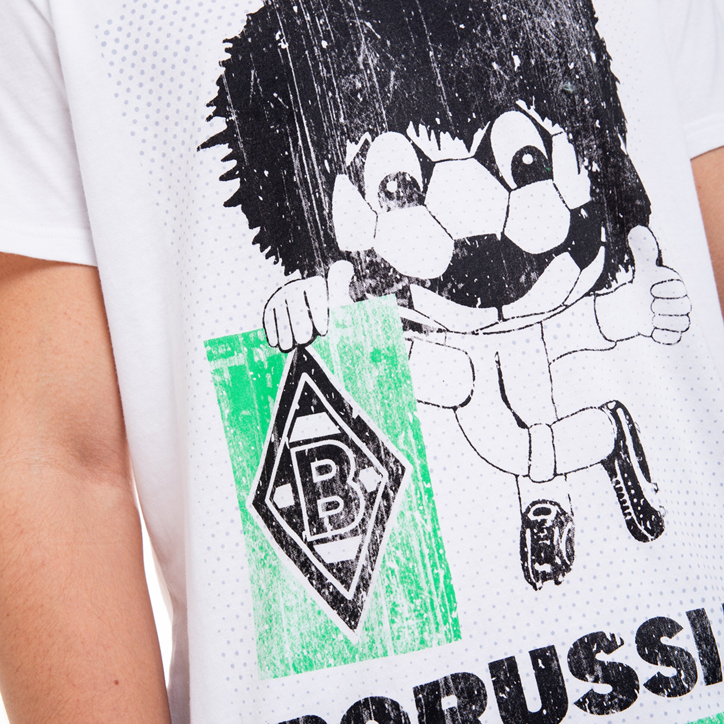 Maskottchen Jünter hält das Borussia Mönchengladbach Logo und gibt einen Daumen hoch.