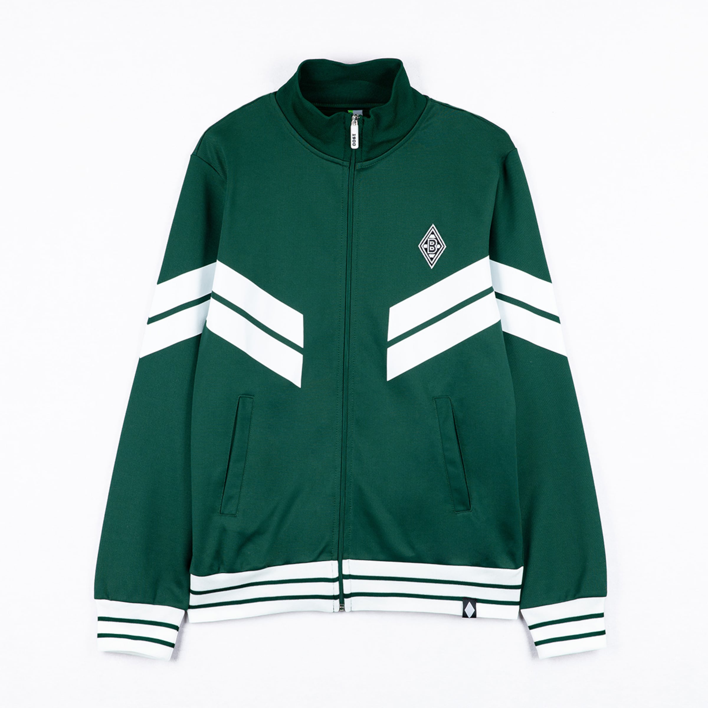 Dunkelgrüne Trainingsjacke mit weißen V-Streifen, gestreiften Bündchen und Rauten-Logo auf der Brust. Durchgehender Reißverschluss.