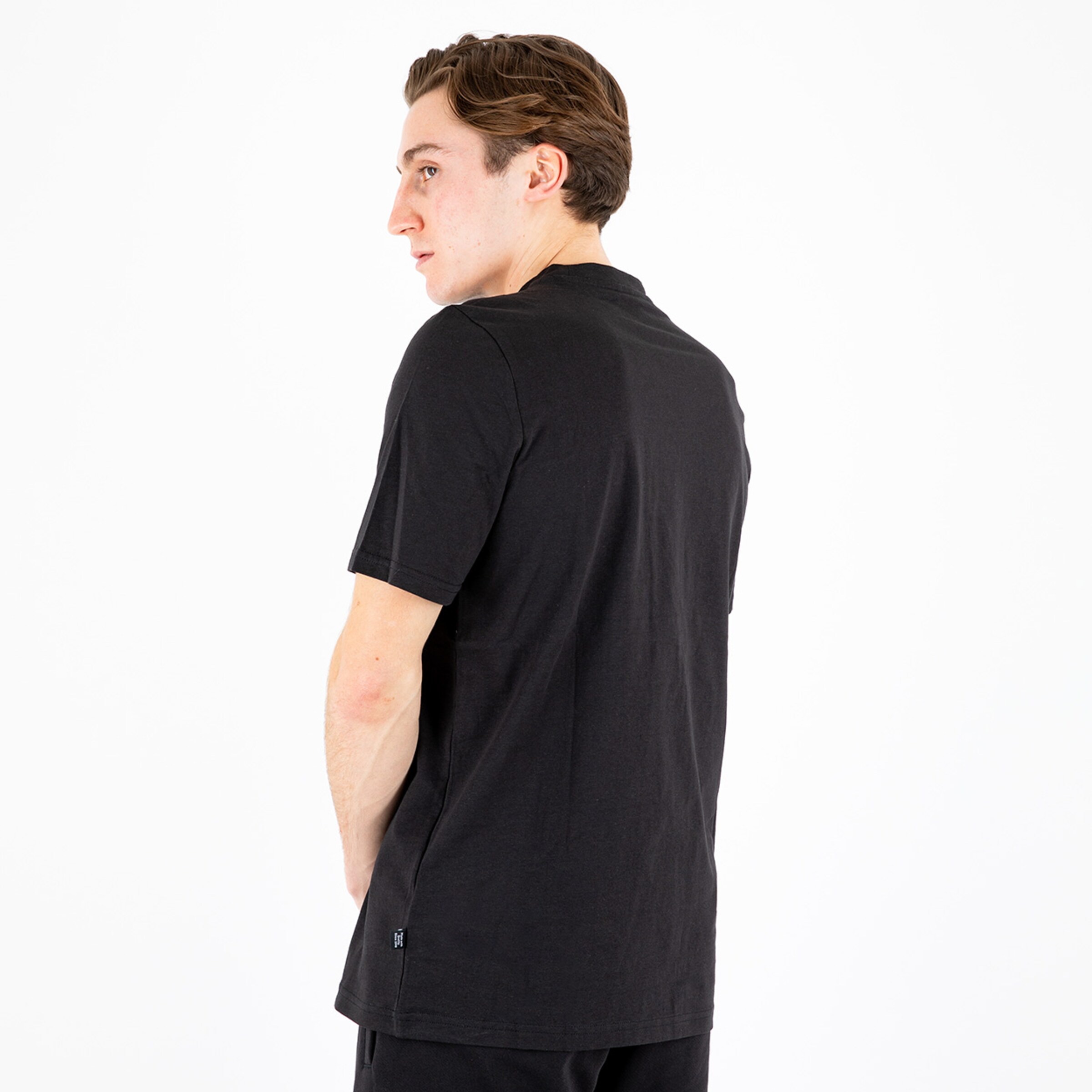 Man seen from behind wearing a black t-shirt