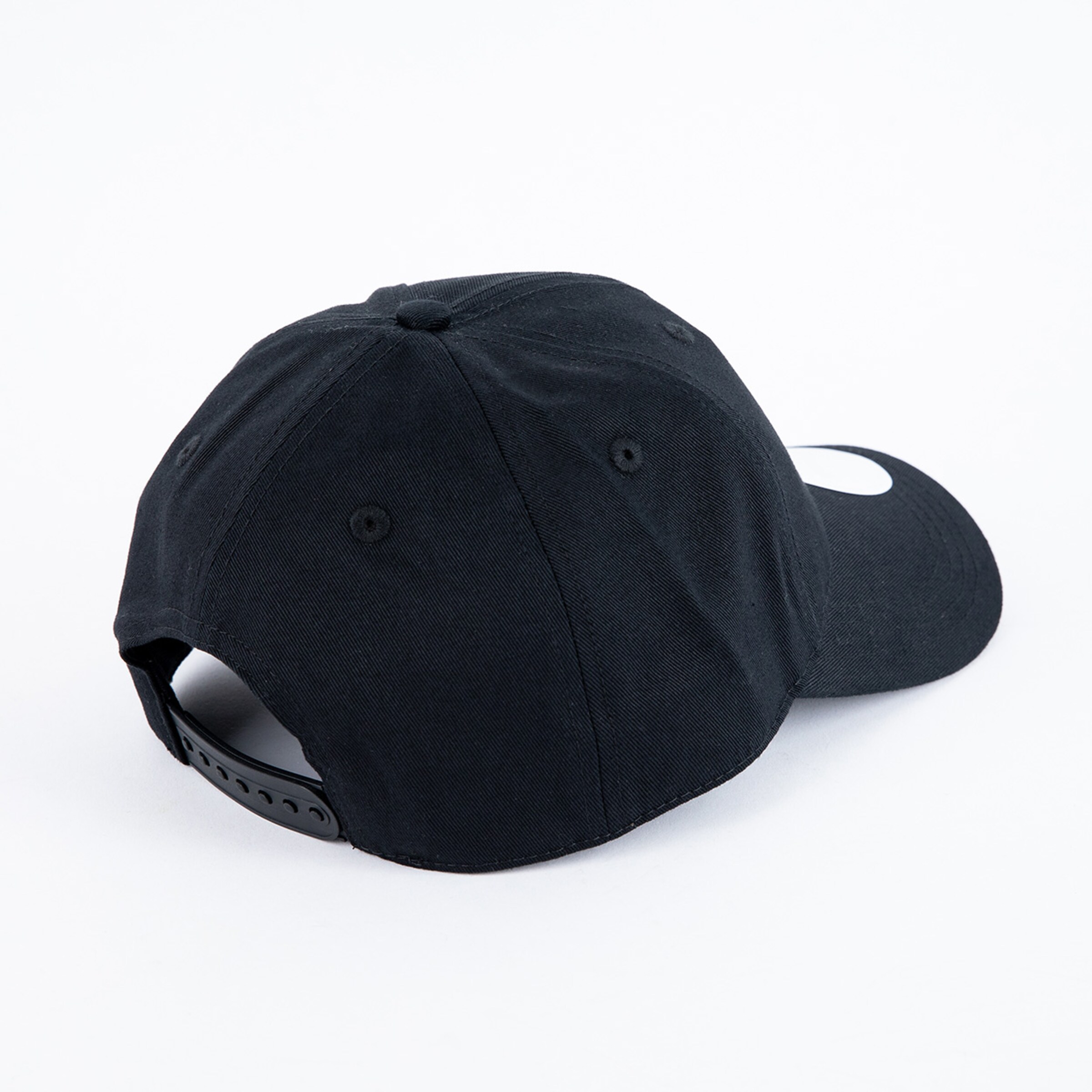 Back view of a black snapback baseball cap with an adjustable plastic strap on a white background.