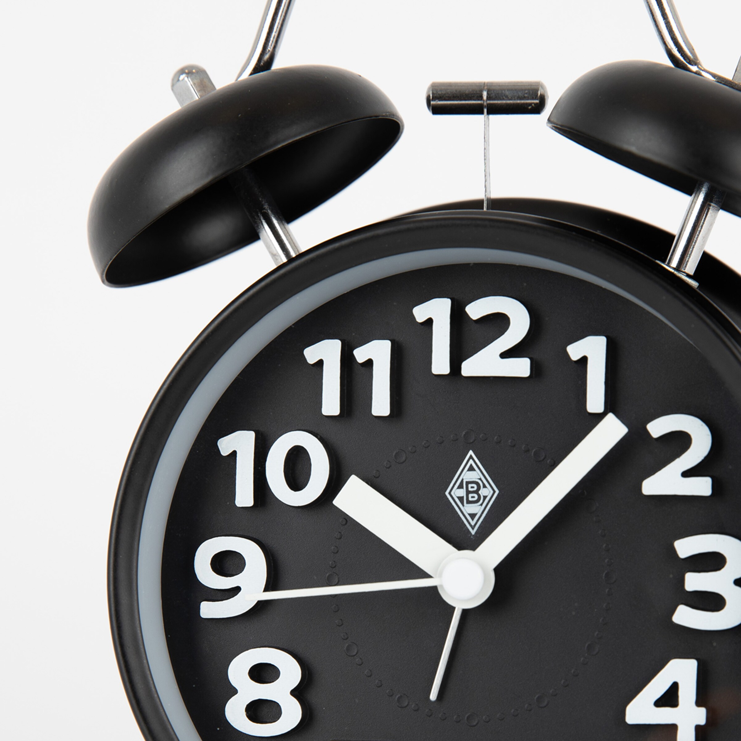 Black twin-bell alarm clock with a Borussia Mönchengladbach logo and a black face with white numerals showing roughly 10:08.