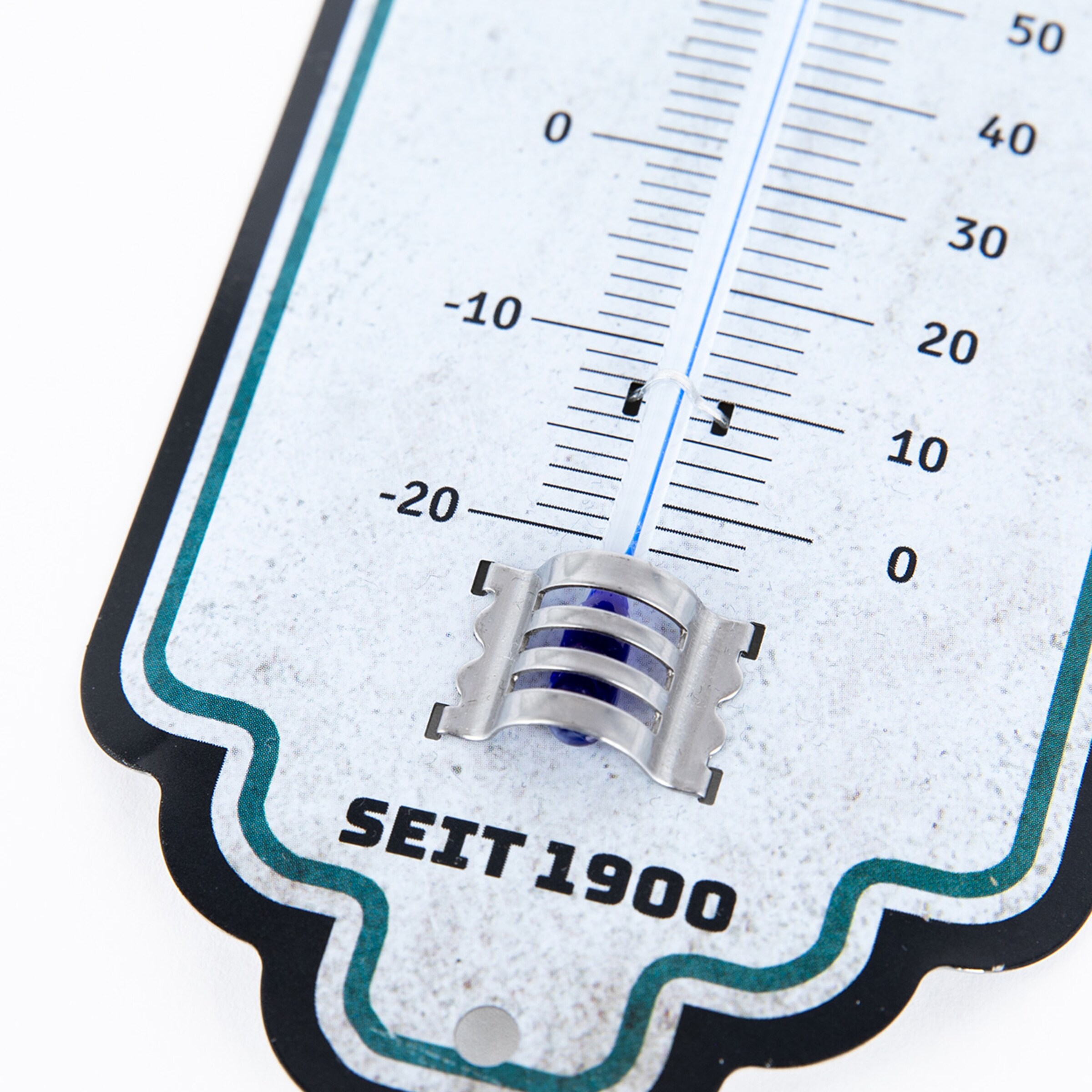 A thermometer featuring a metallic holder and the text SEIT 1900.