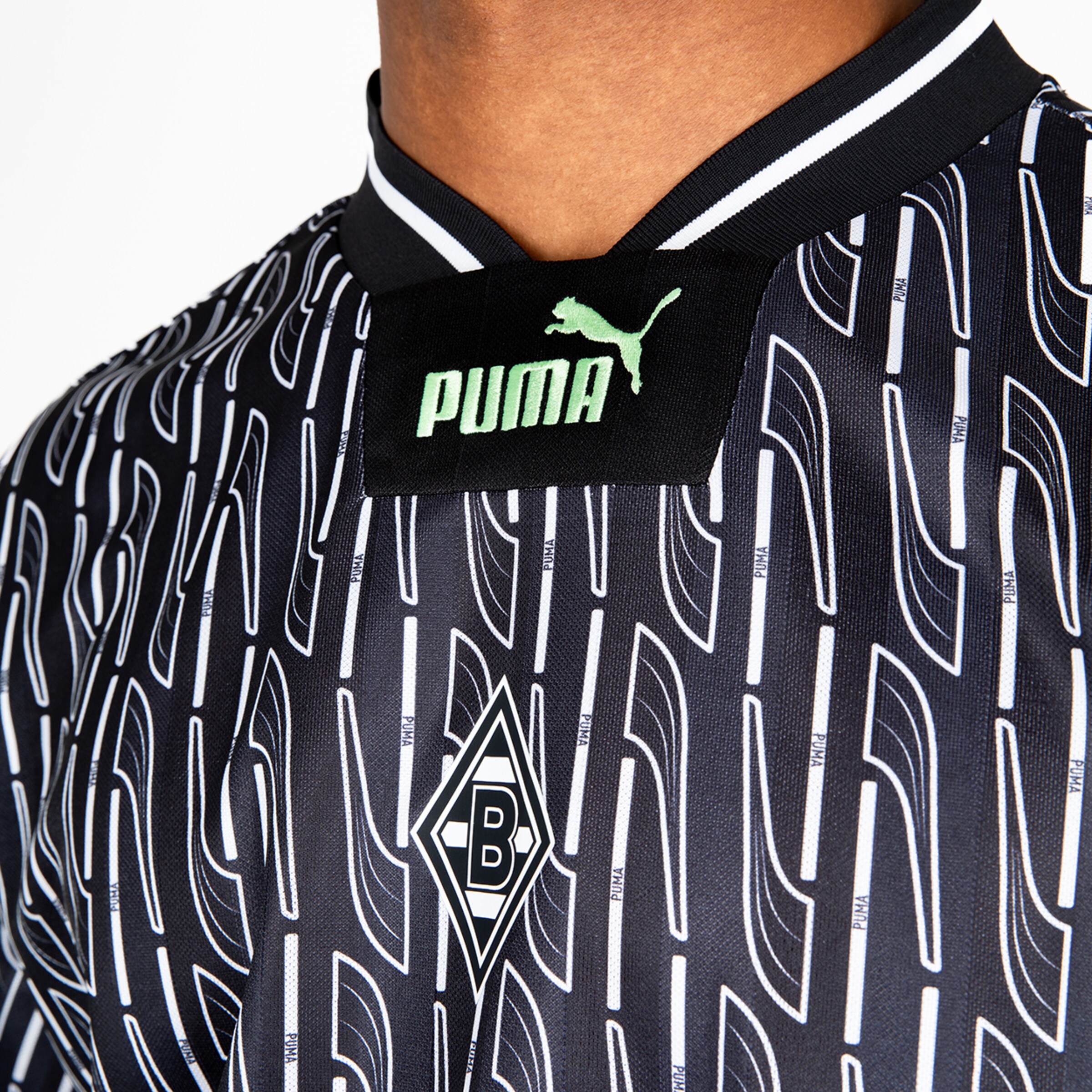 Detailaufnahme eines Fußballtrikots mit Puma-Logo und Borussia Mönchengladbach-Emblem.