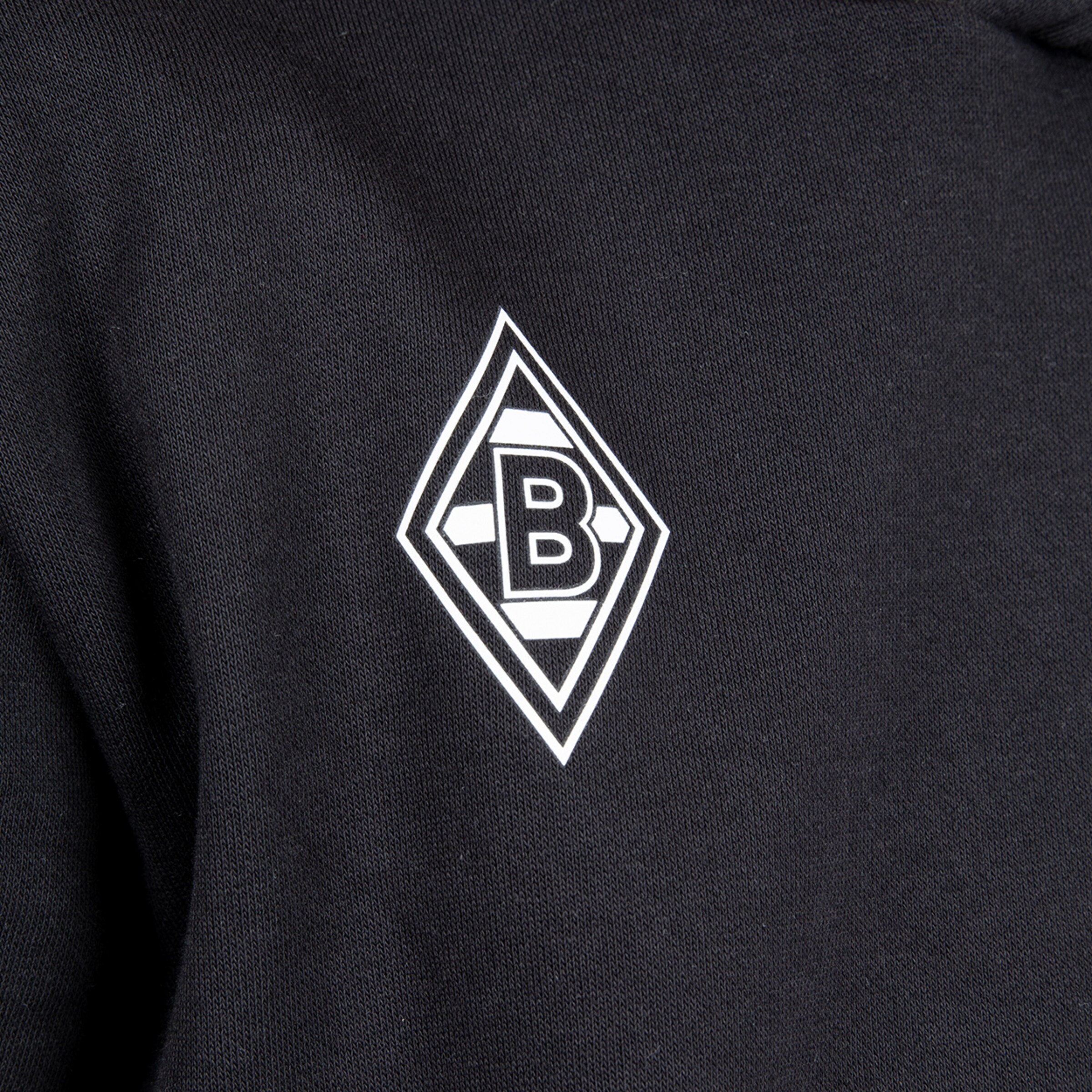 Logo of Borussia Mönchengladbach on black fabric.