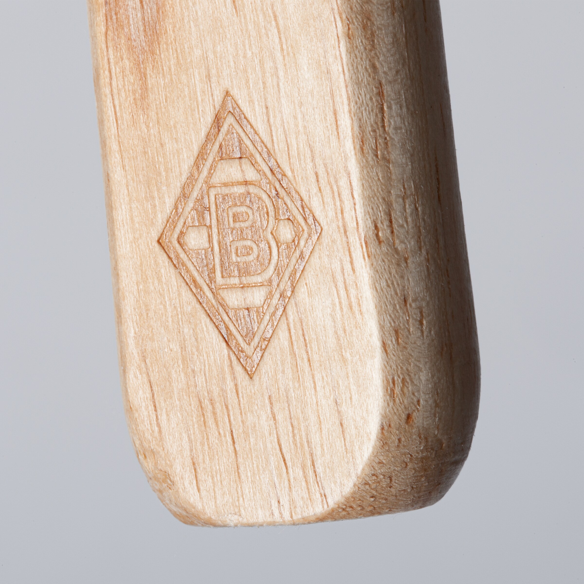 Engraved Borussia Mönchengladbach logo on a wooden object.