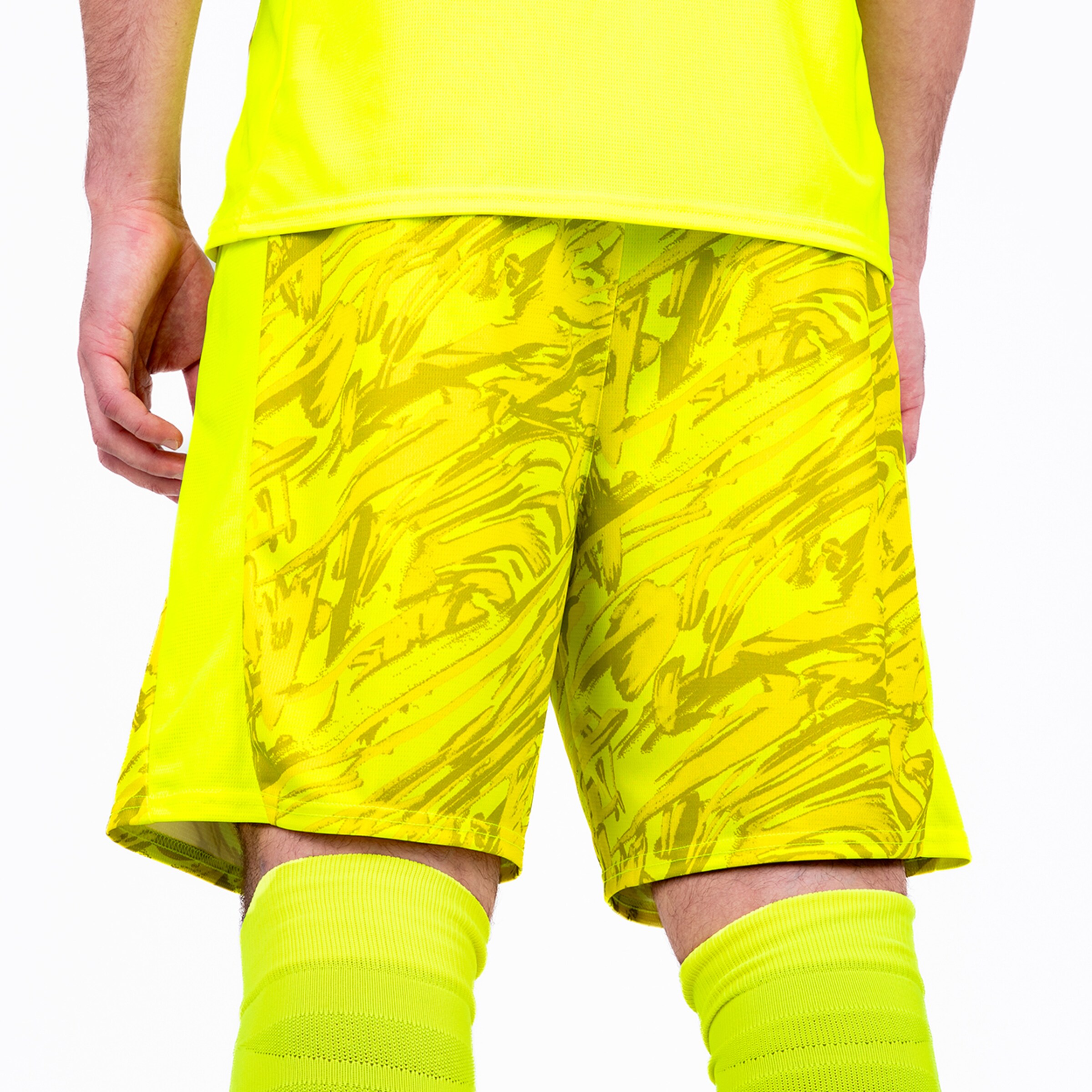 Rear view of a person wearing yellow sports shorts with an abstract pattern.