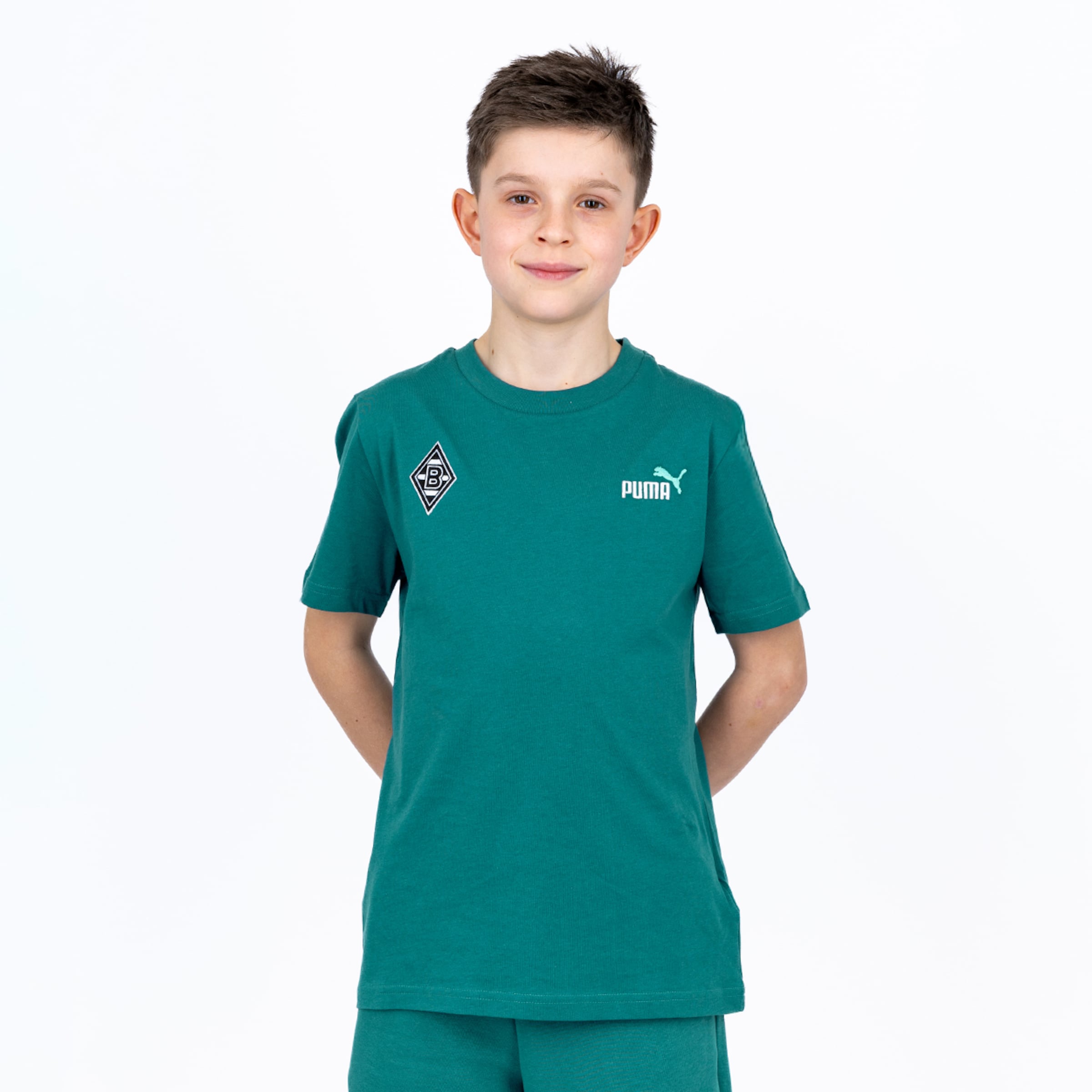 A boy in a green Puma t-shirt with a Borussia Mönchengladbach crest and matching shorts against a white background.