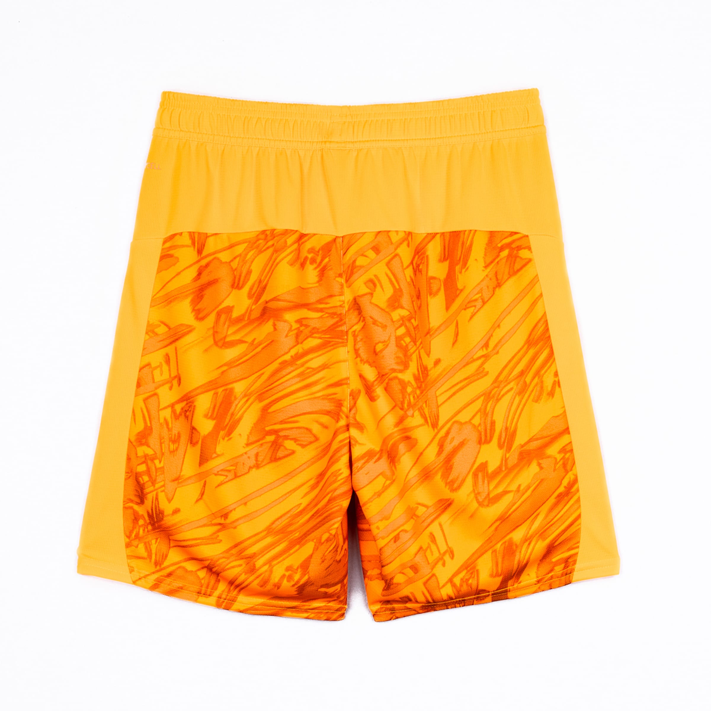 Yellow sports shorts with a patterned background.