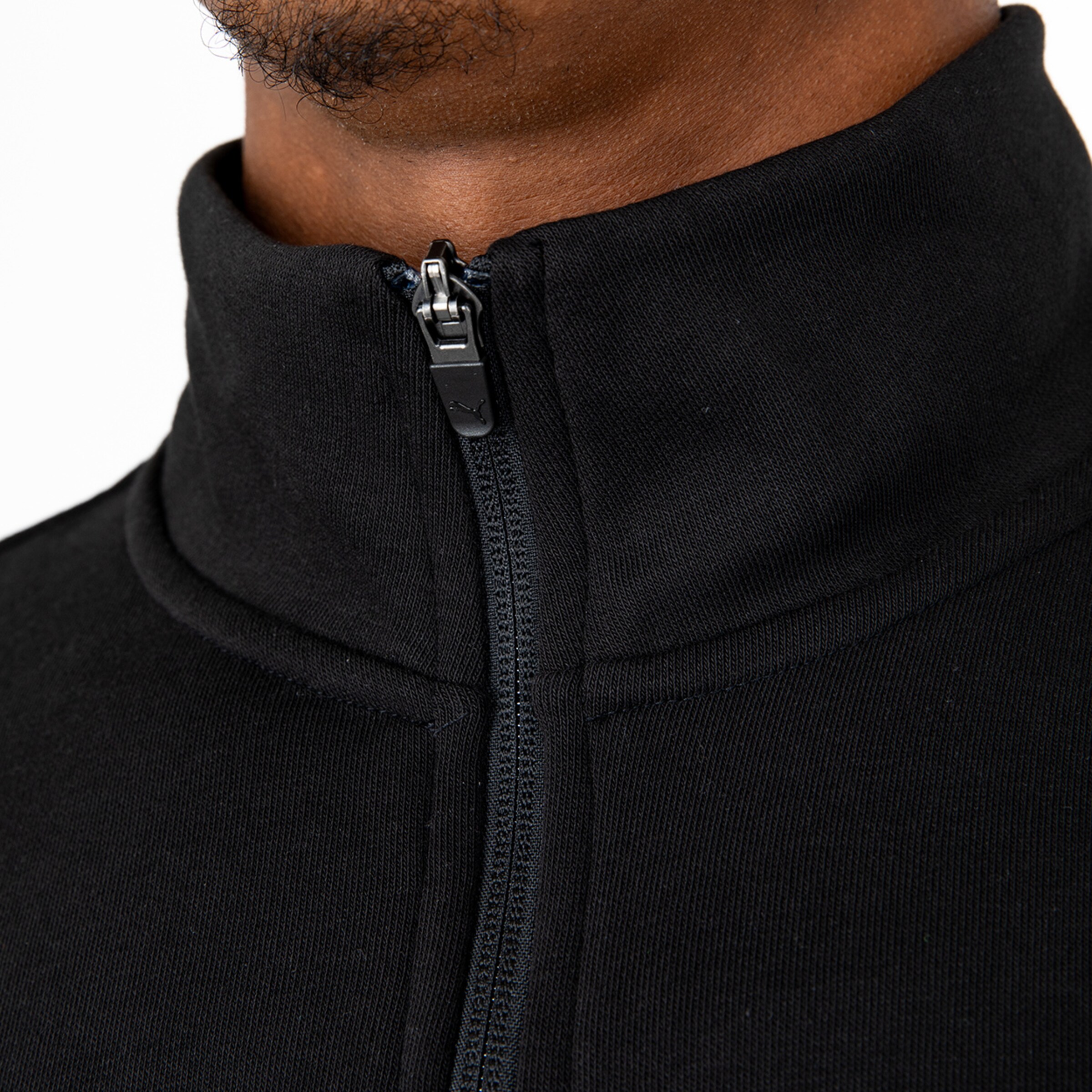 Close-up of a black sports top with a zipper collar
