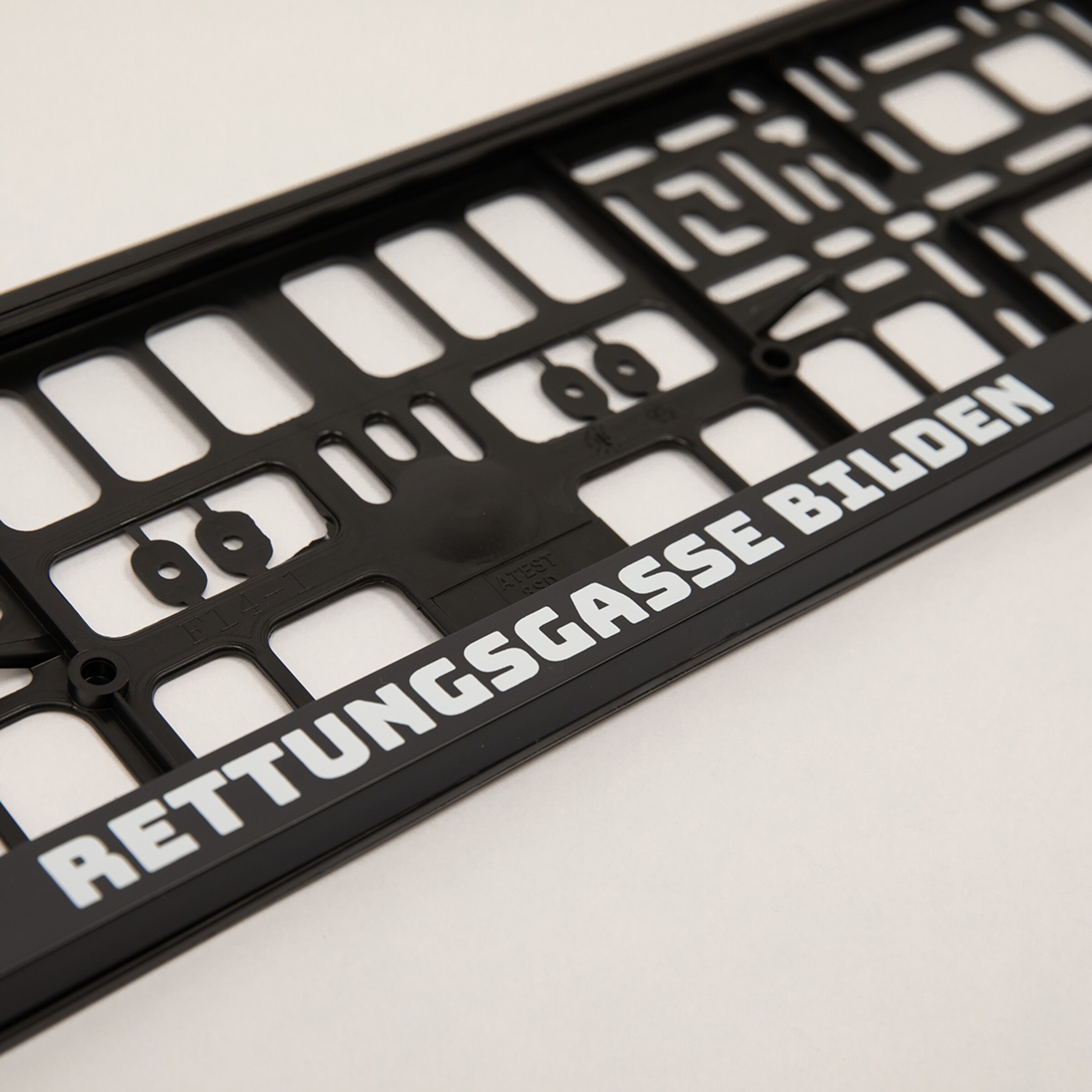 Ein schwarzes Nummernschild mit der Aufschrift RETTUNGSGASSE BILDEN.
