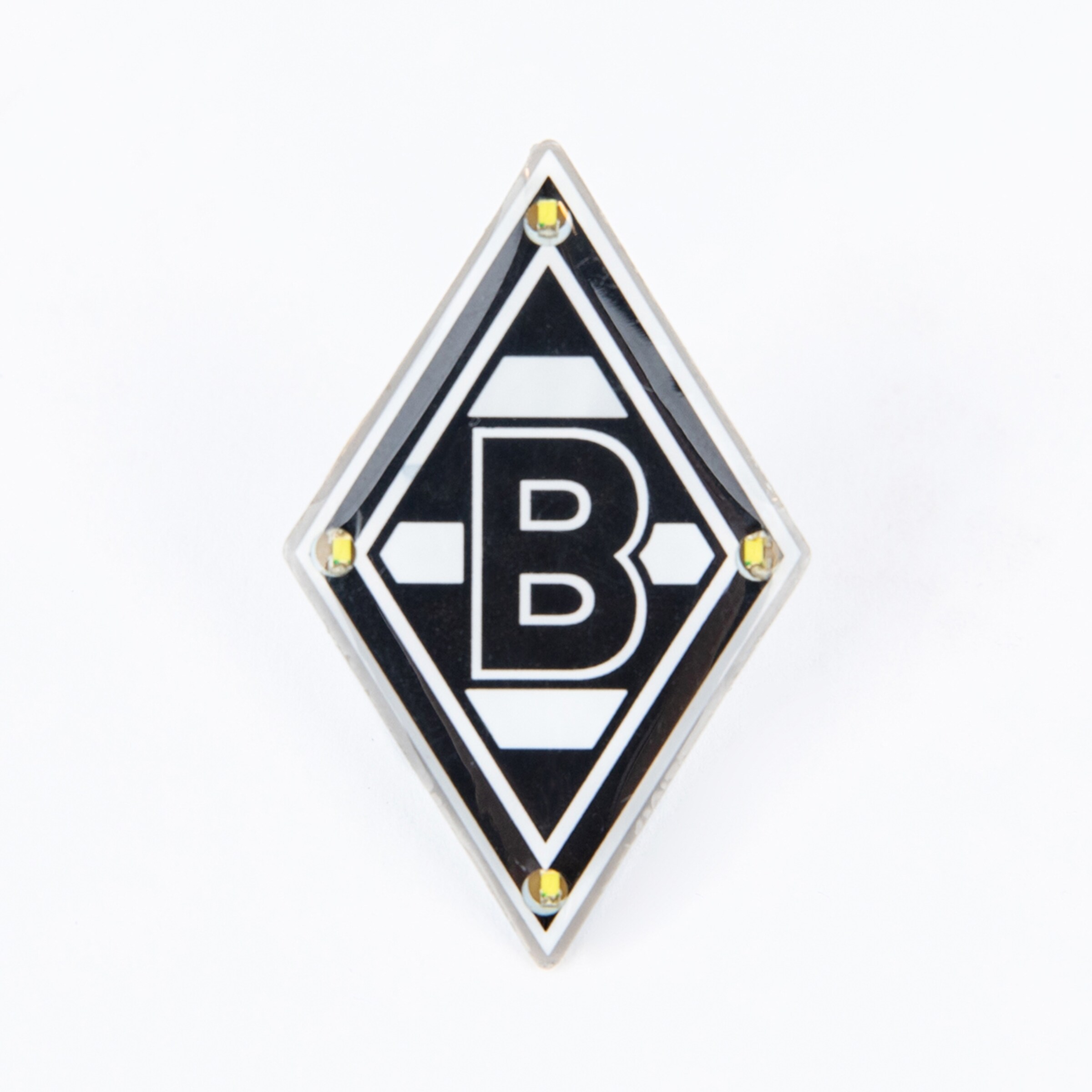 Rauten-Logo von Borussia Mönchengladbach in Schwarz-Weiß mit einem zentralen 'B' und vier gelben Zierelementen an den inneren Ecken.