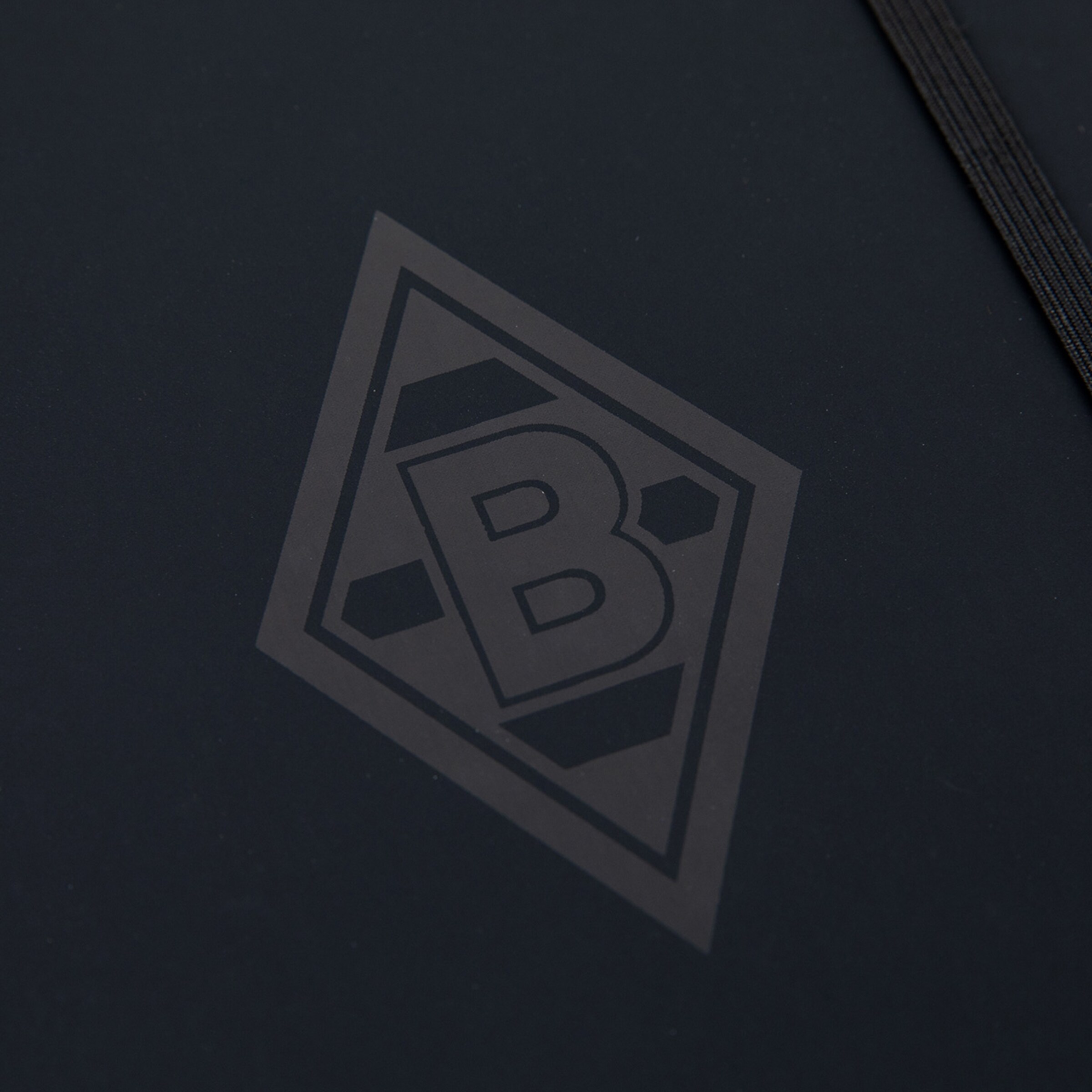 Logo von Borussia Mönchengladbach in grauer Farbe auf schwarzem Hintergrund