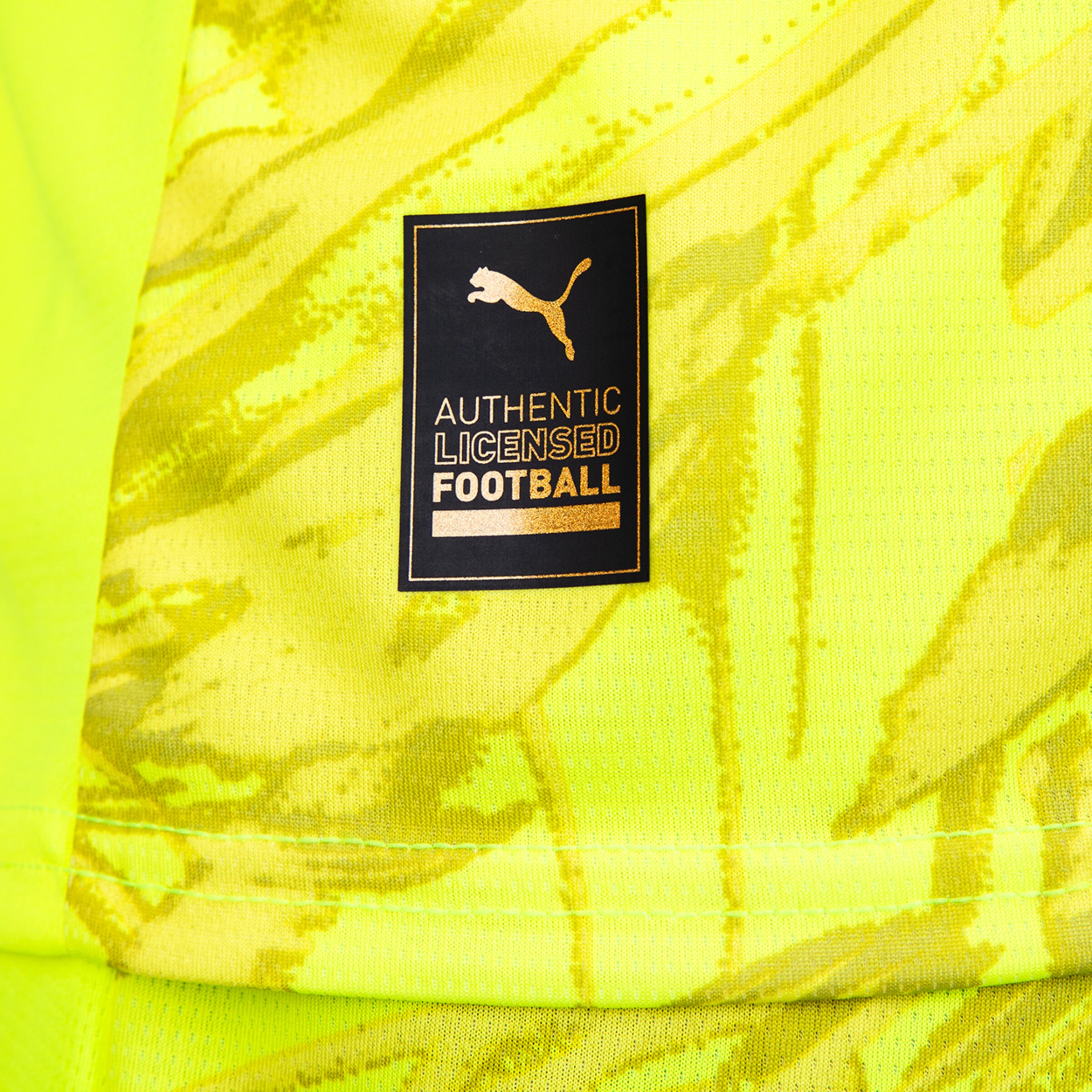 PUMA logo on a neon yellow football jersey with the text AUTHENTIC LICENSED FOOTBALL.