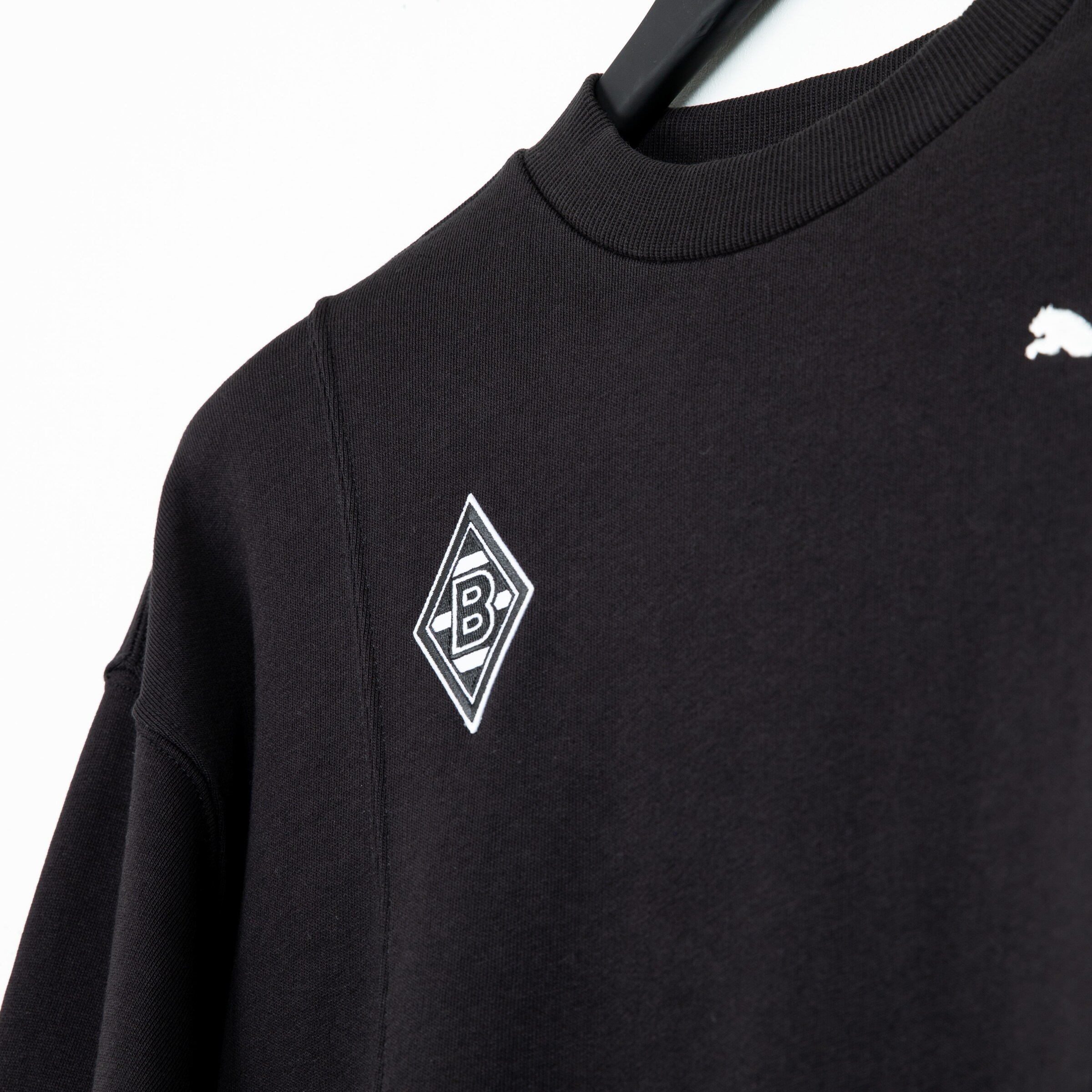 Black sweatshirt featuring the Borussia Mönchengladbach logo on the chest.