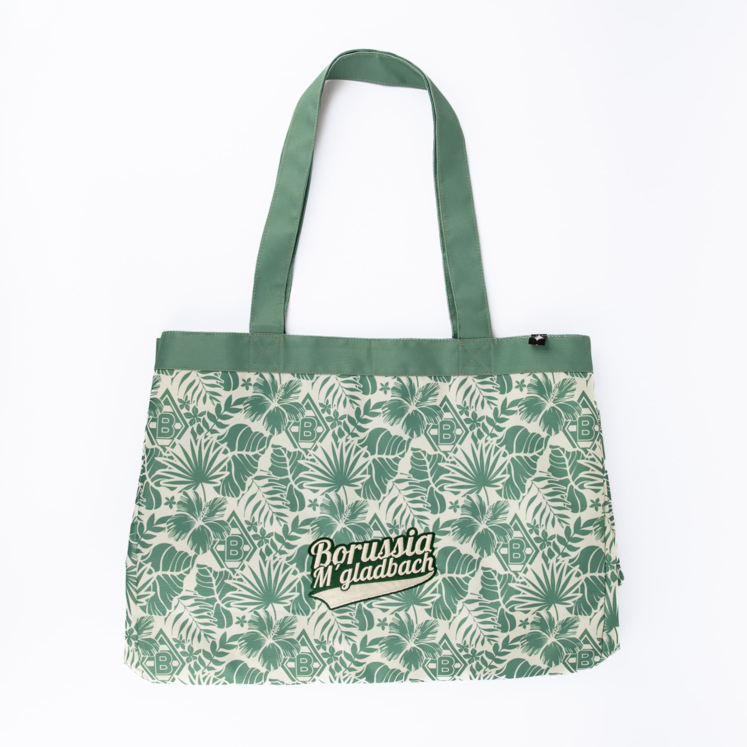 Grüne Stofftasche mit tropischem Blatt- und Blütenmuster in Grün und Creme. Die Tasche zeigt den Schriftzug 'Borussia M'gladbach' und 'B'-Logos. Sie hat grüne Henkel und einen Reißverschluss.