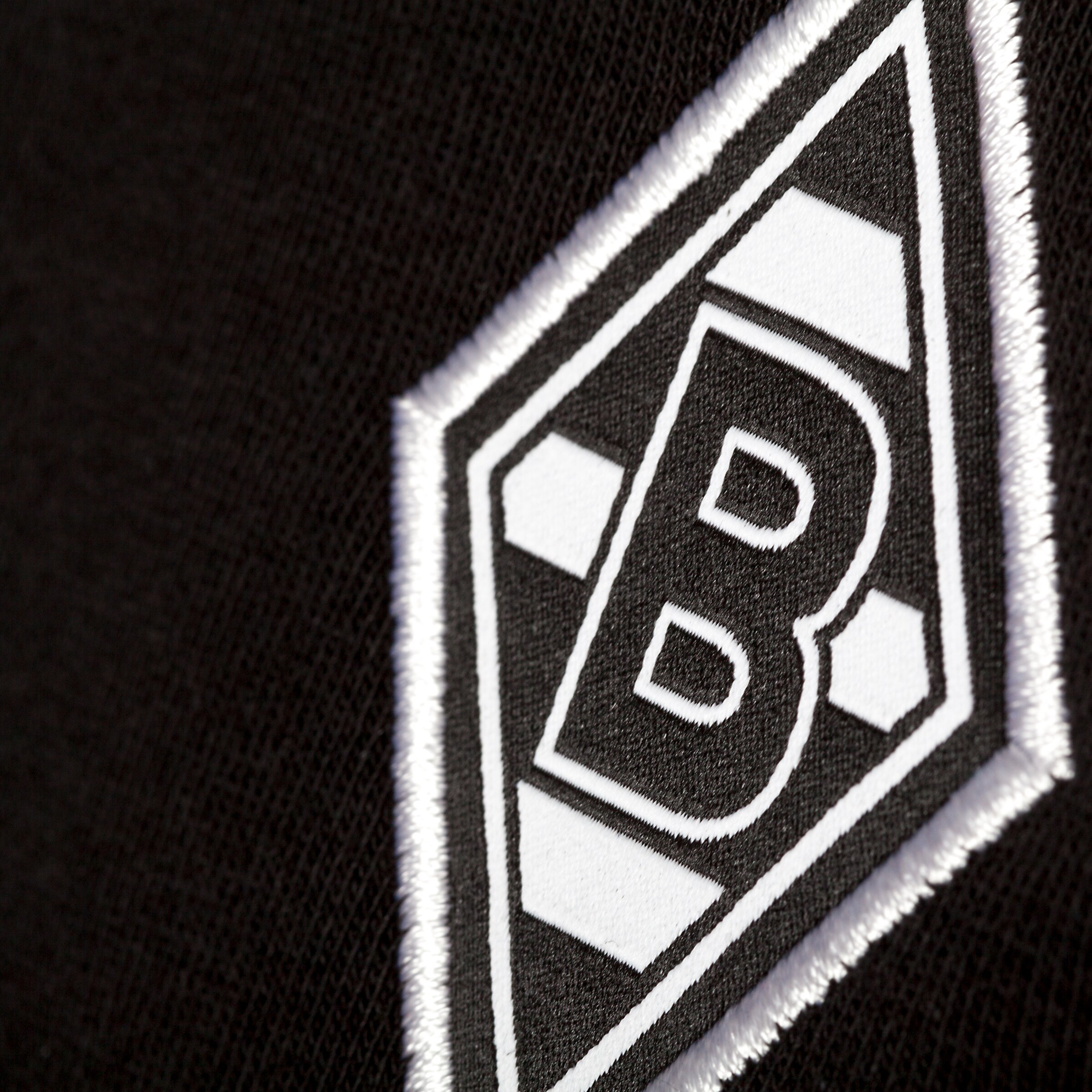 Close-up of Borussia Mönchengladbach logo on black fabric.