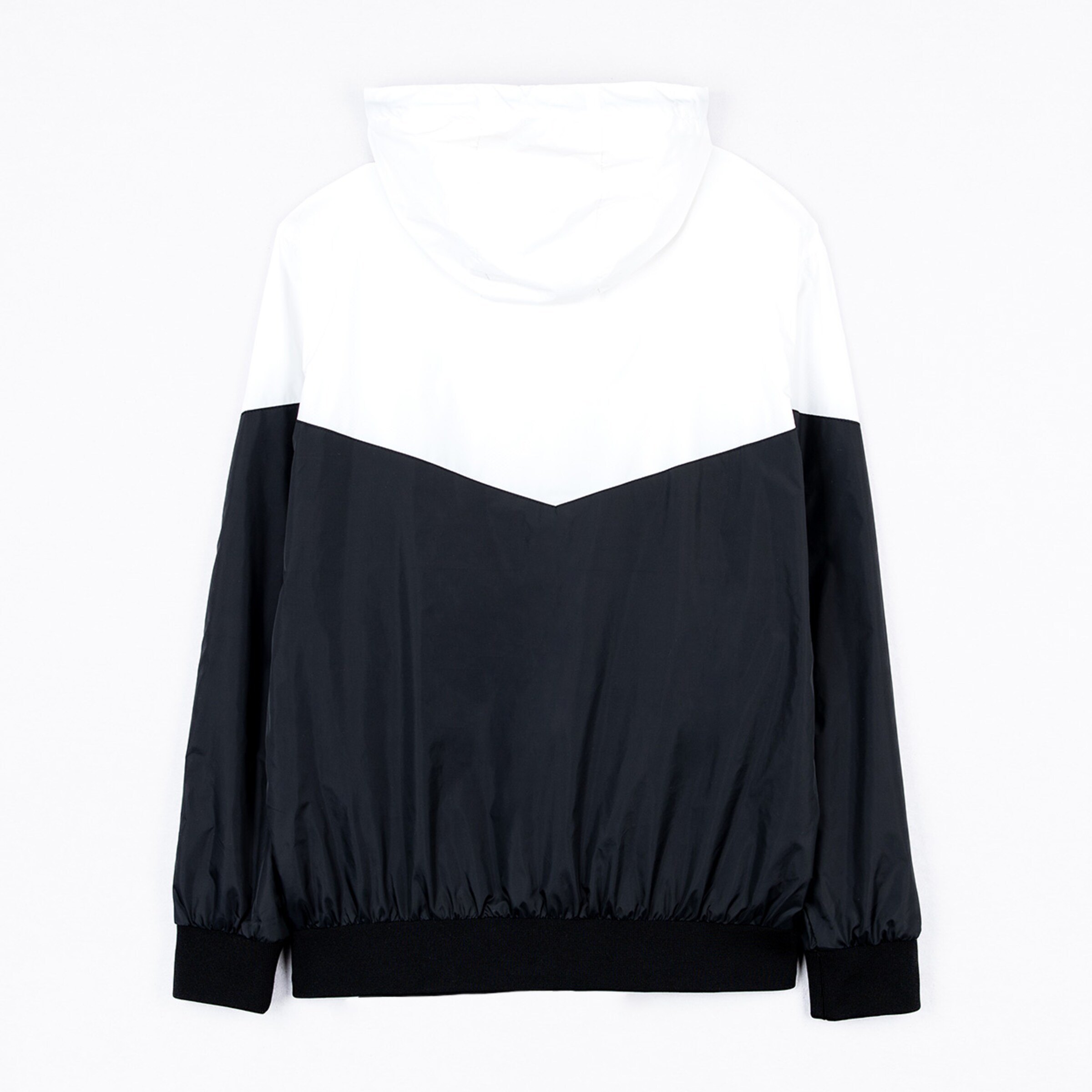Black and white hooded jacket rear view featuring an elastic hem.