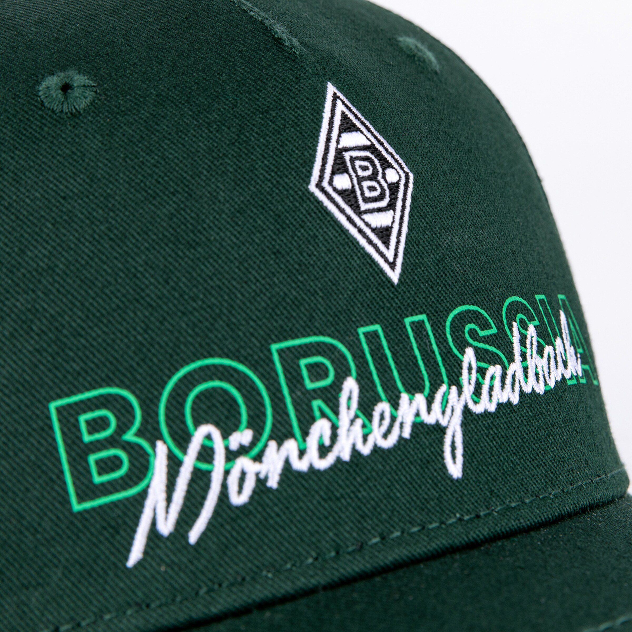Close-up of a dark green cap featuring the Borussia Mönchengladbach logo and team name in green outline letters and white script font.