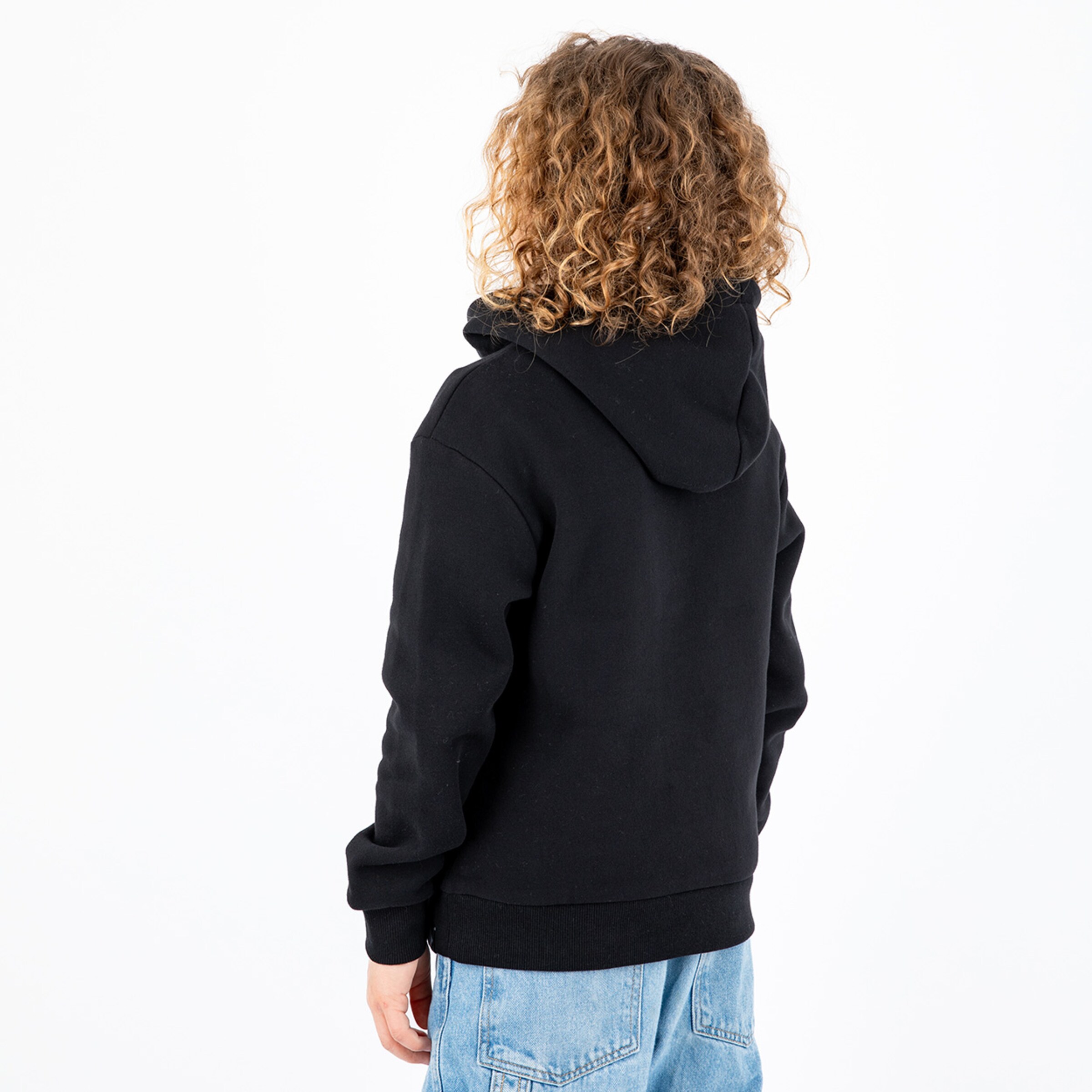 Person with curly hair wearing a black hooded sweatshirt facing away from the camera.
