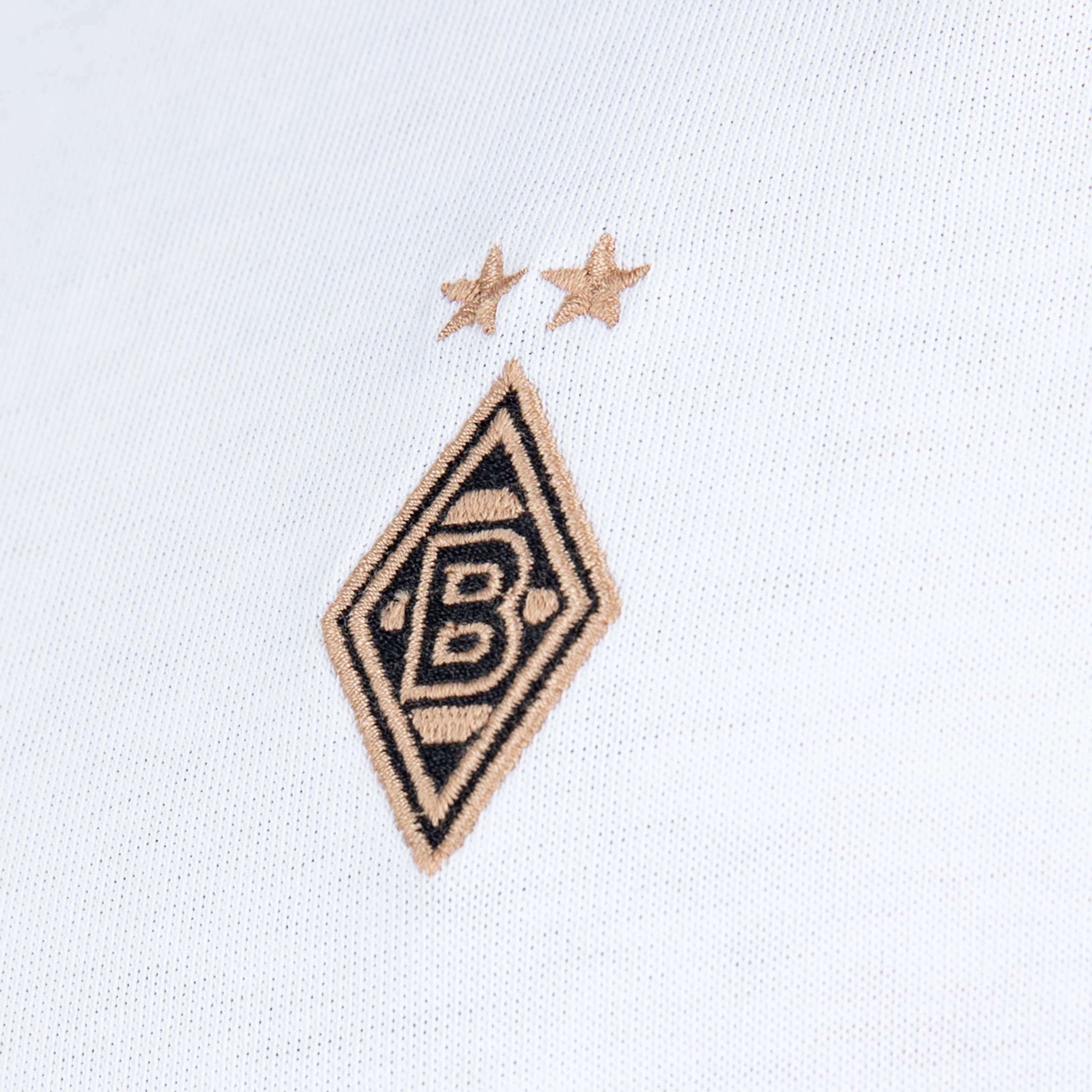 Besticktes gold-schwarzes Borussia Mönchengladbach Logo mit zwei Sternen auf weißem Stoff.