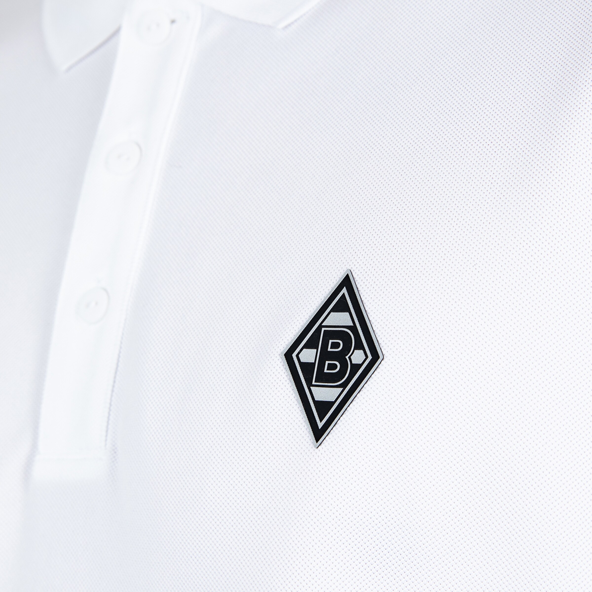 Logo of Borussia Mönchengladbach on a white polo shirt.