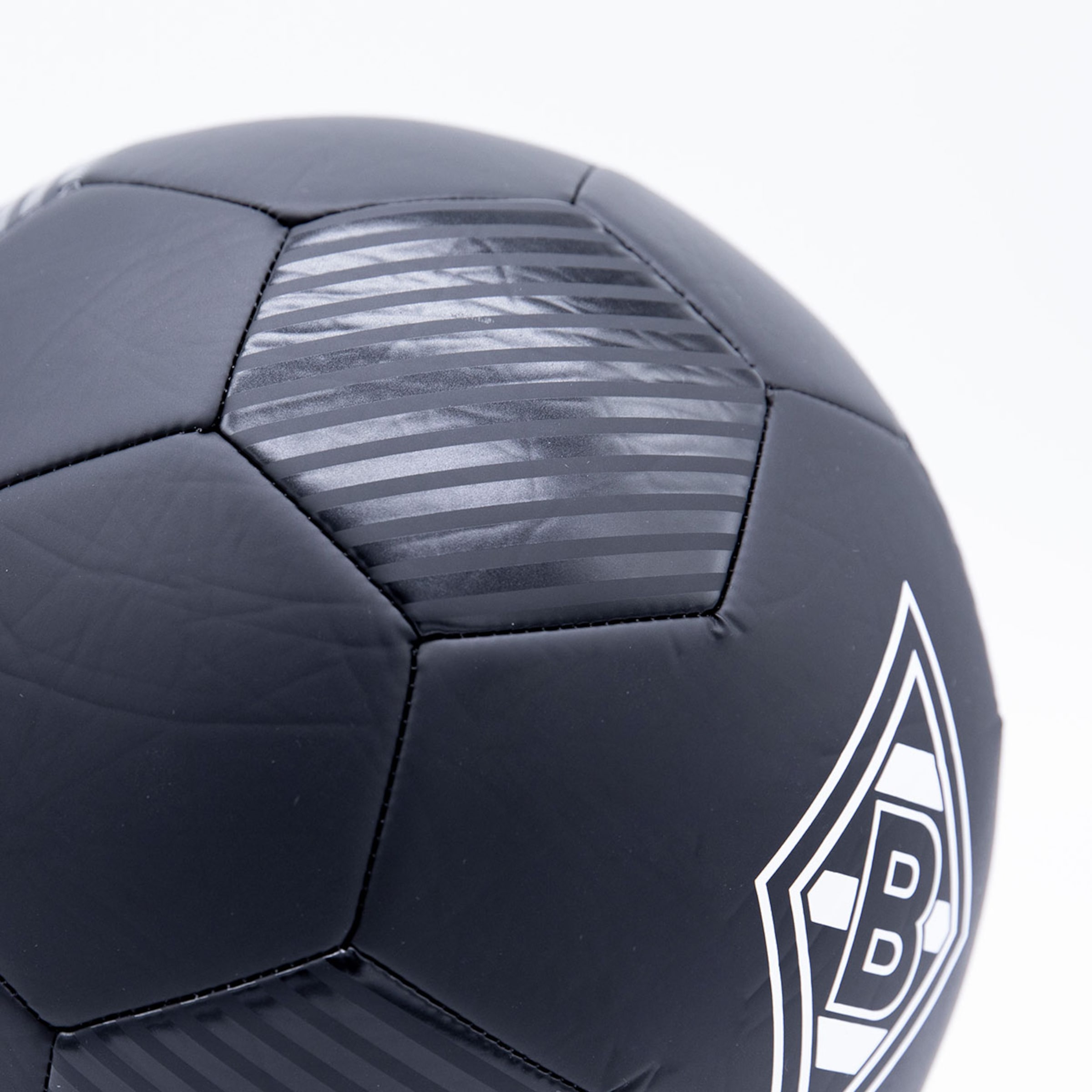 Black football with striped details and the white Borussia Mönchengladbach club logo on a white background.