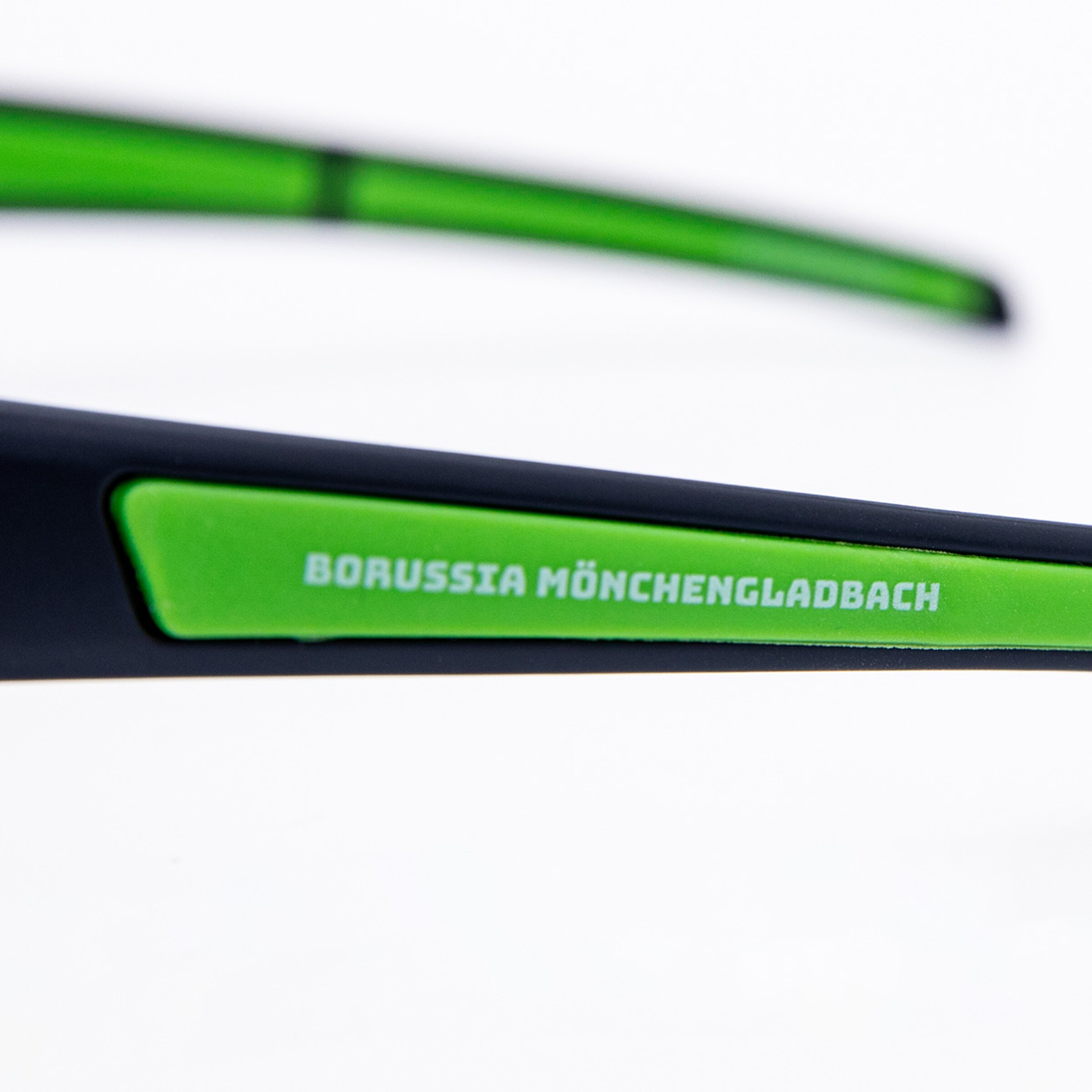 Close-up of glasses featuring Borussia Mönchengladbach printed on the frame.