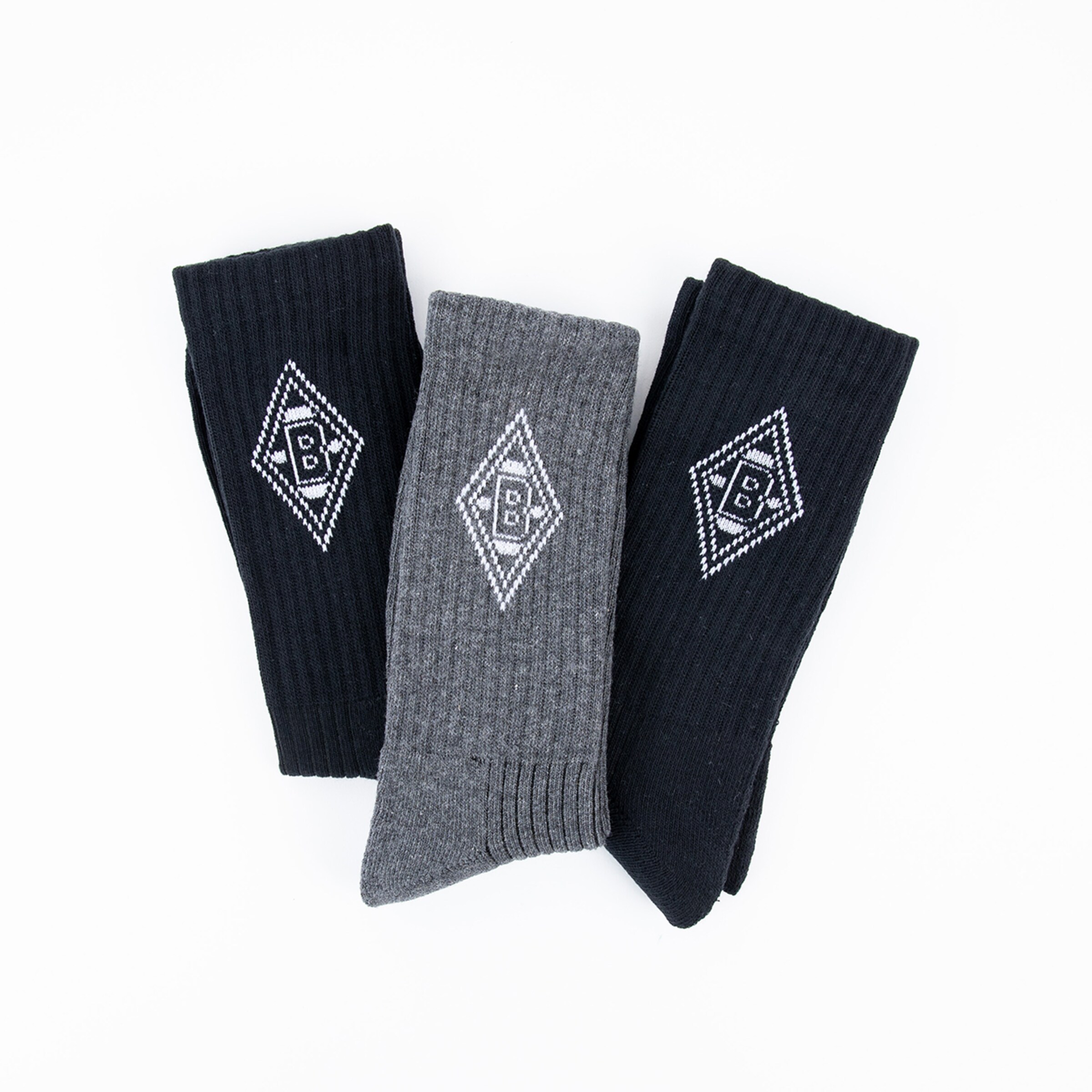 Three pairs of socks in different colors featuring the Borussia Mönchengladbach logo.