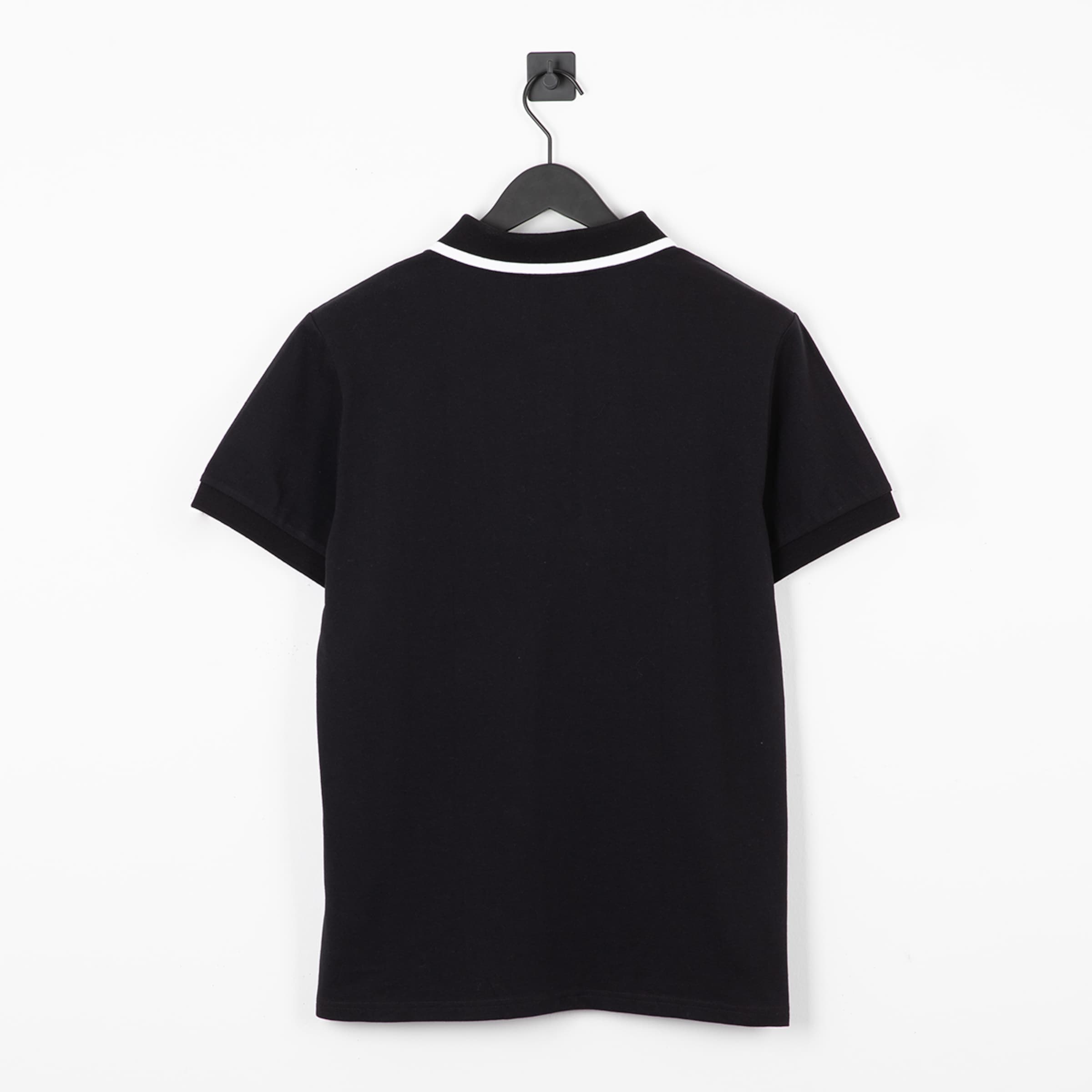 Black short-sleeve T-shirt with white collar viewed from the back.