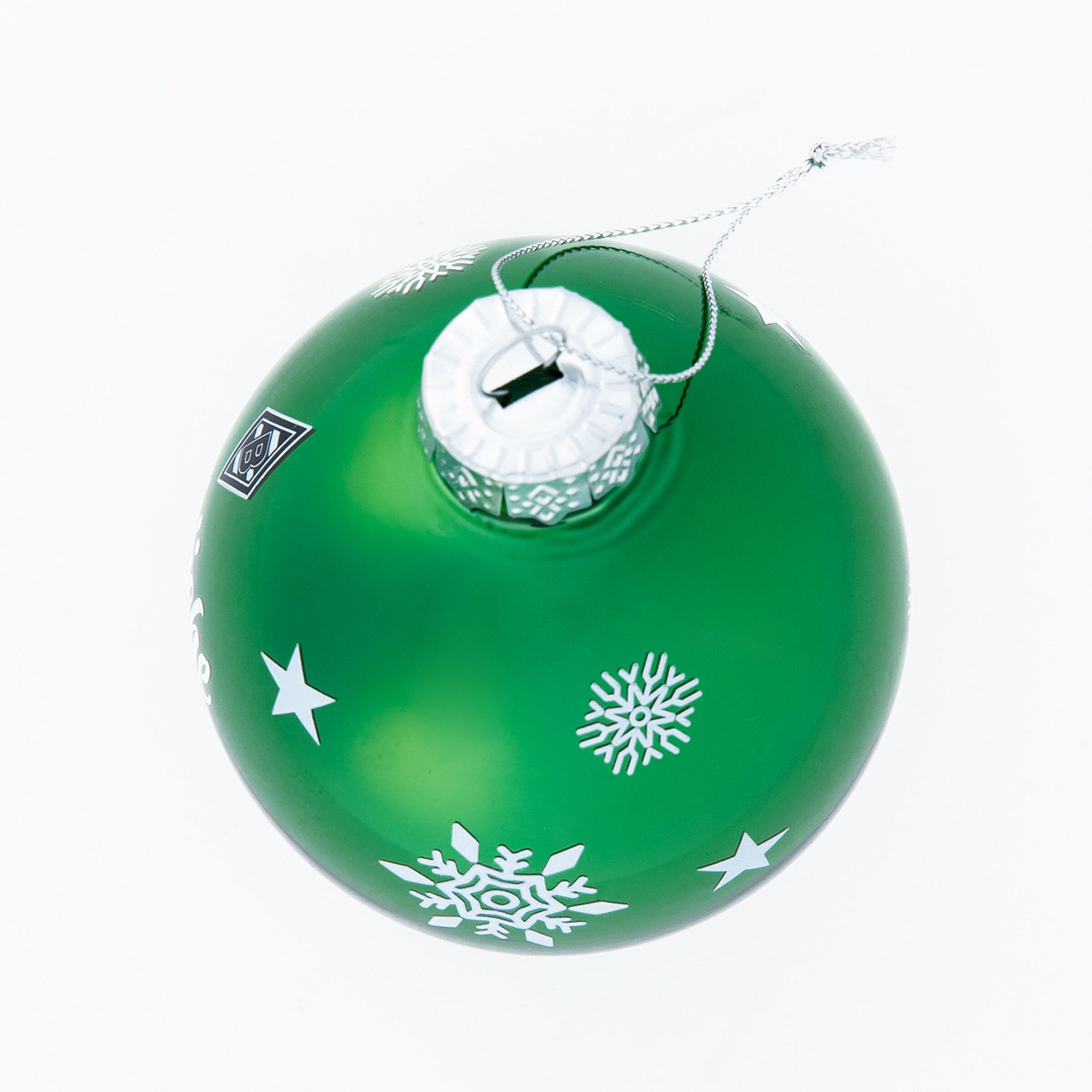 Green Christmas ornament with white star and snowflake patterns.