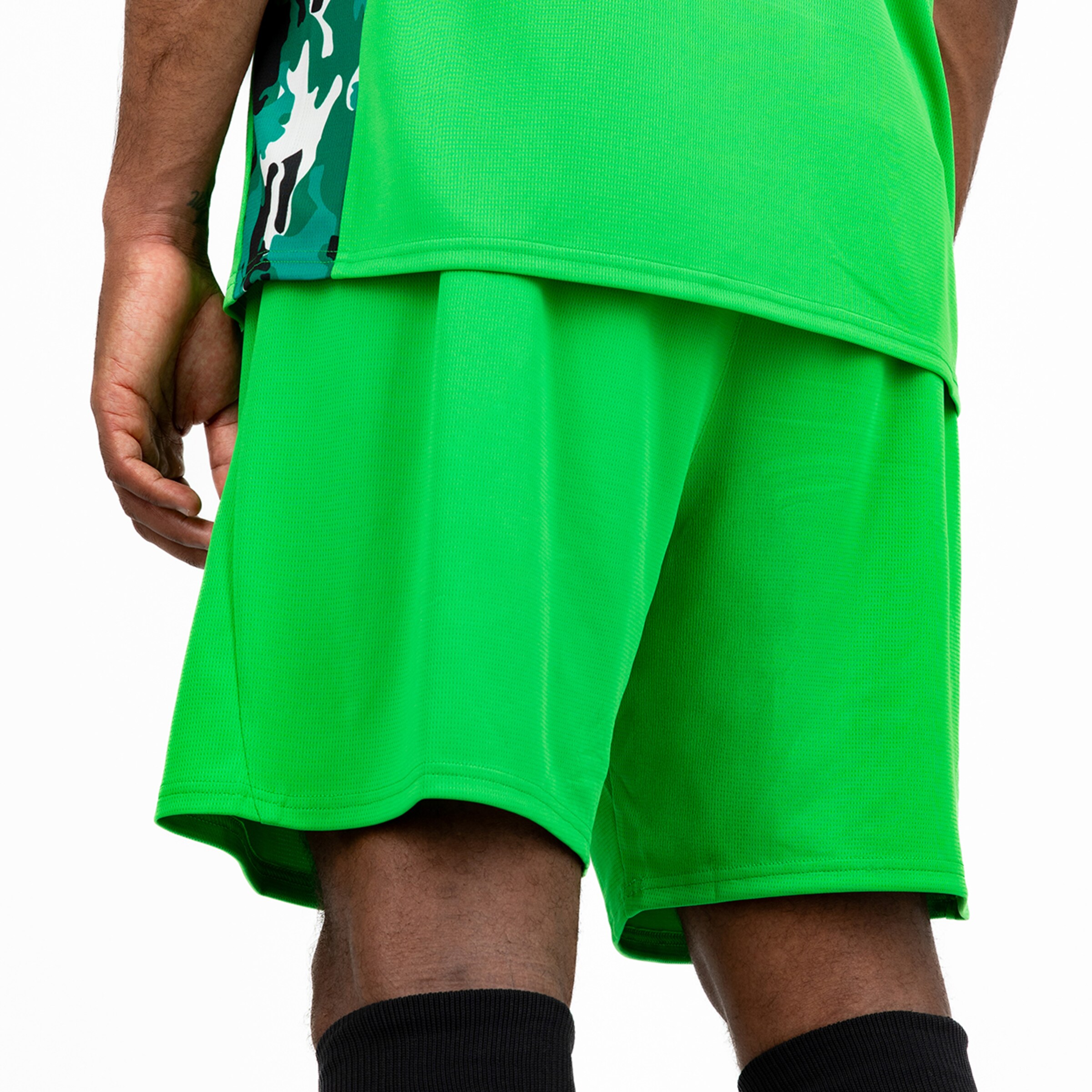 Green soccer jersey and shorts with a graphic pattern on the side.