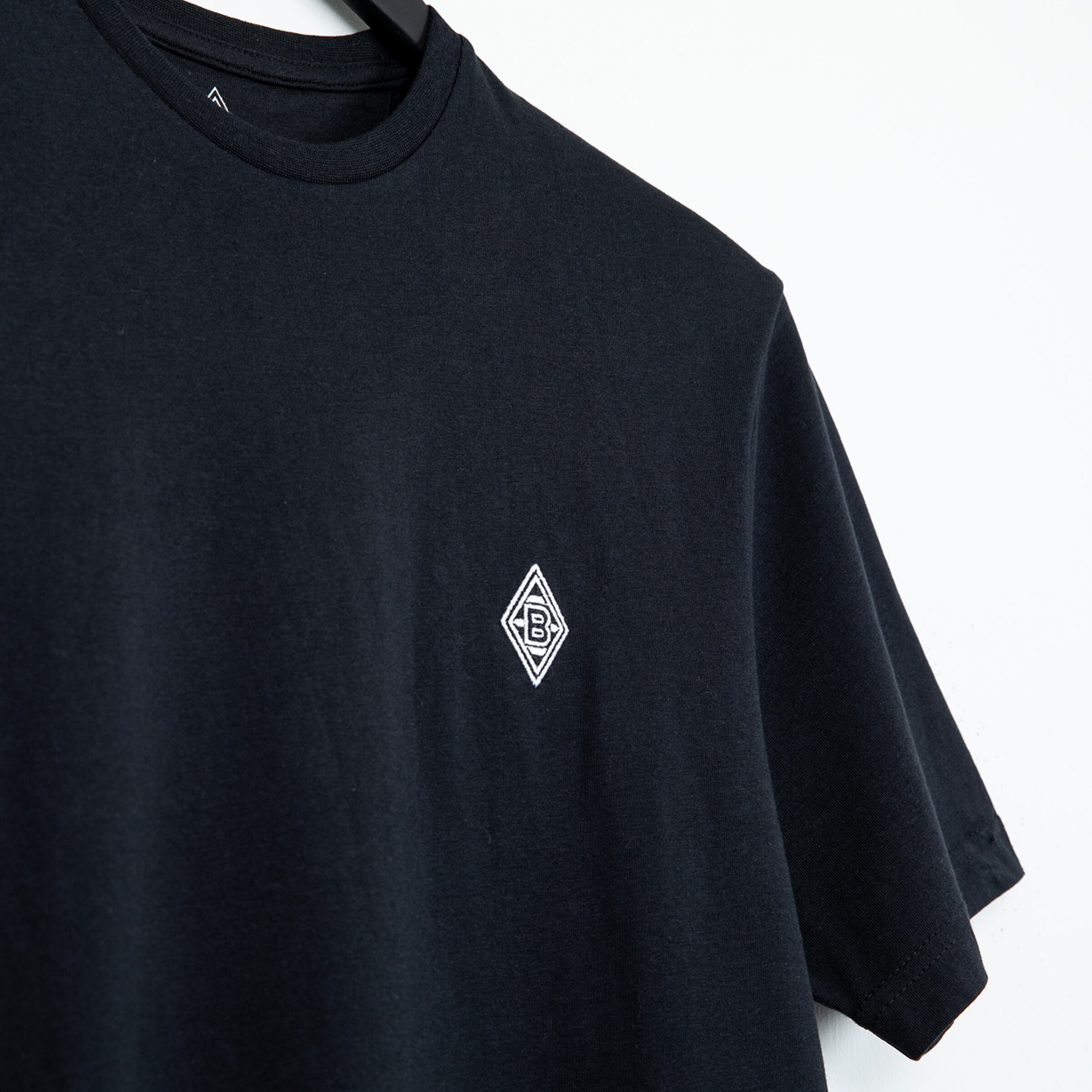 Black T-shirt featuring the Borussia Mönchengladbach logo on the chest.