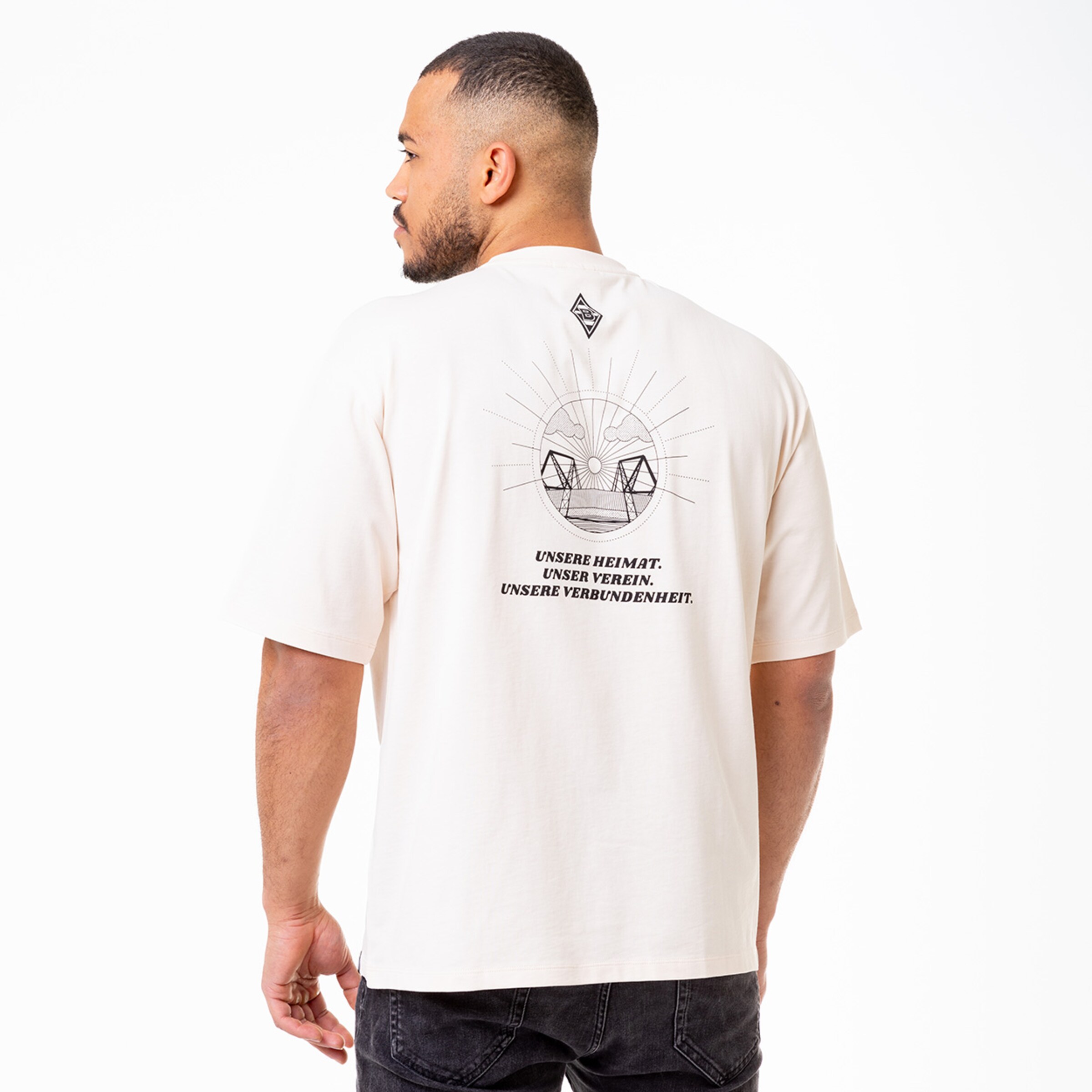 Man wearing a T-shirt back view shows graphic design with the text OUR HOME OUR CLUB OUR CONNECTION.